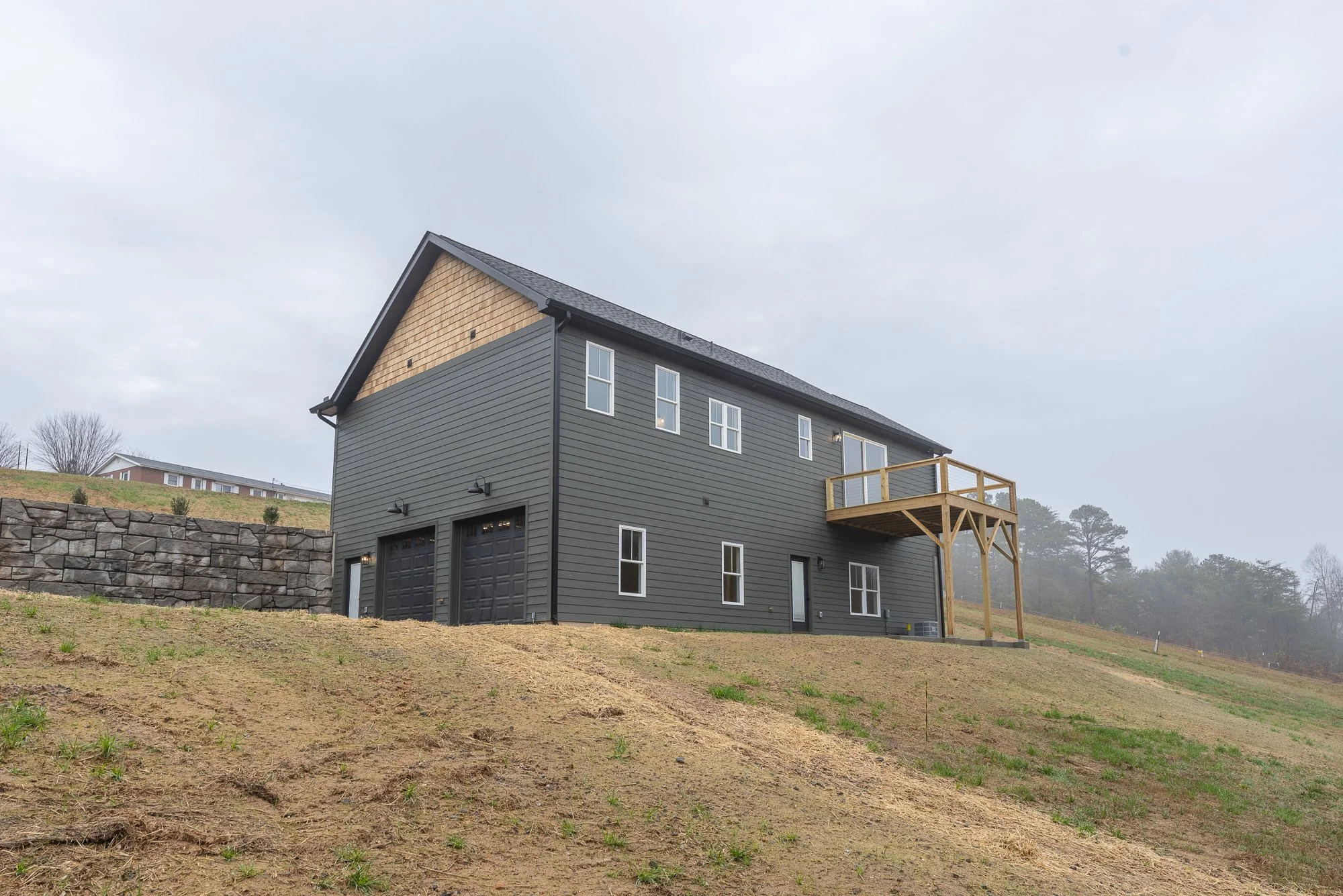 Rear elevation of a dark green home by Plumb Level Square in Asheville, NC