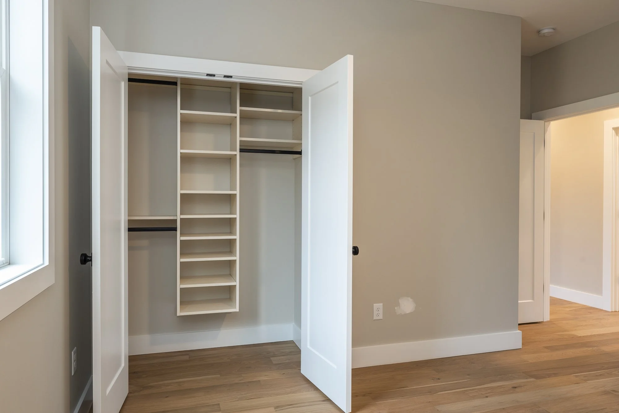 Bedroom and closet in a modern farmhouse constructed by Plumb Level Square builders in western North Carolina.