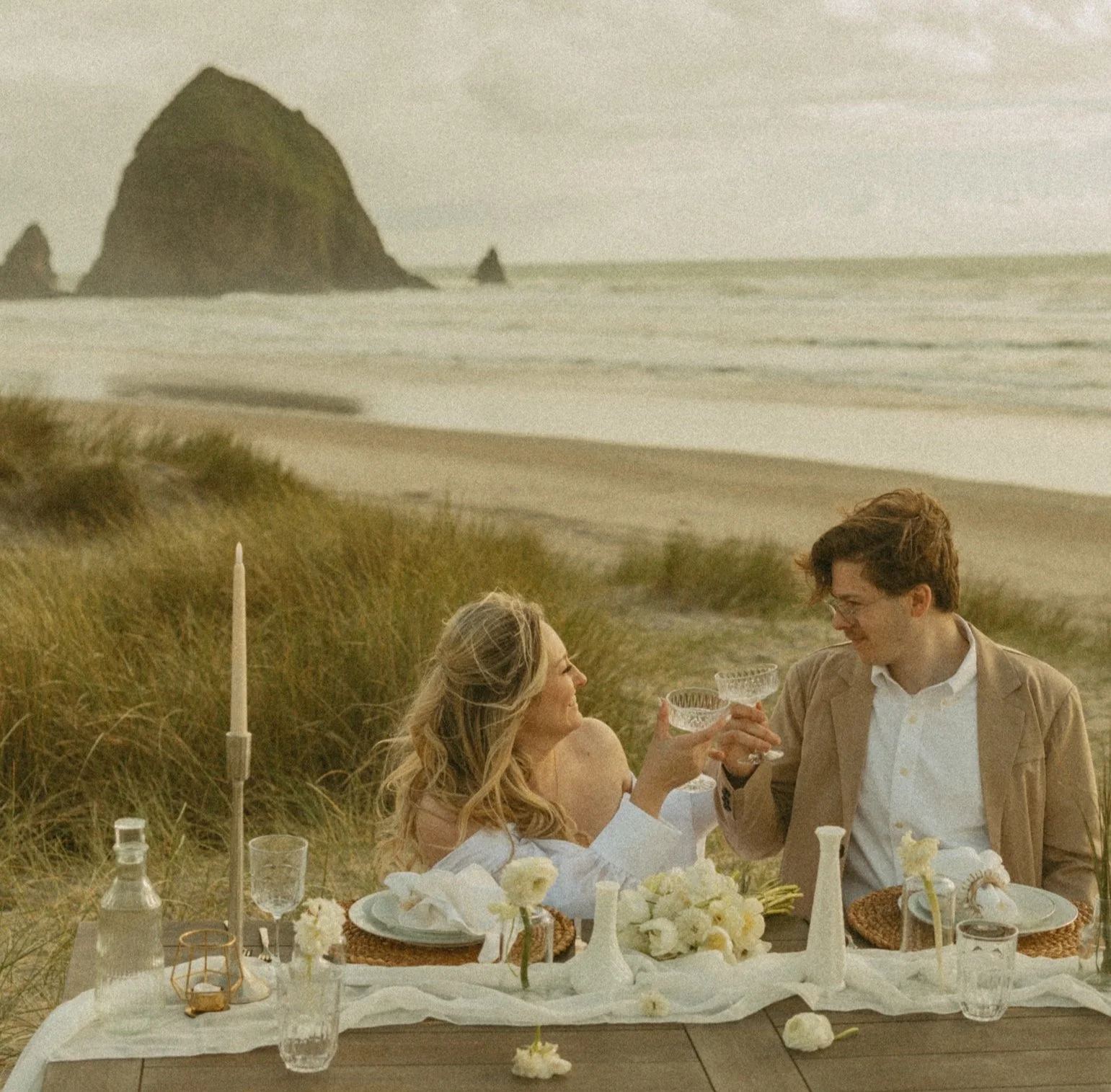 couple sharing a beachside picnic after their elopement on the Oregon Coast
