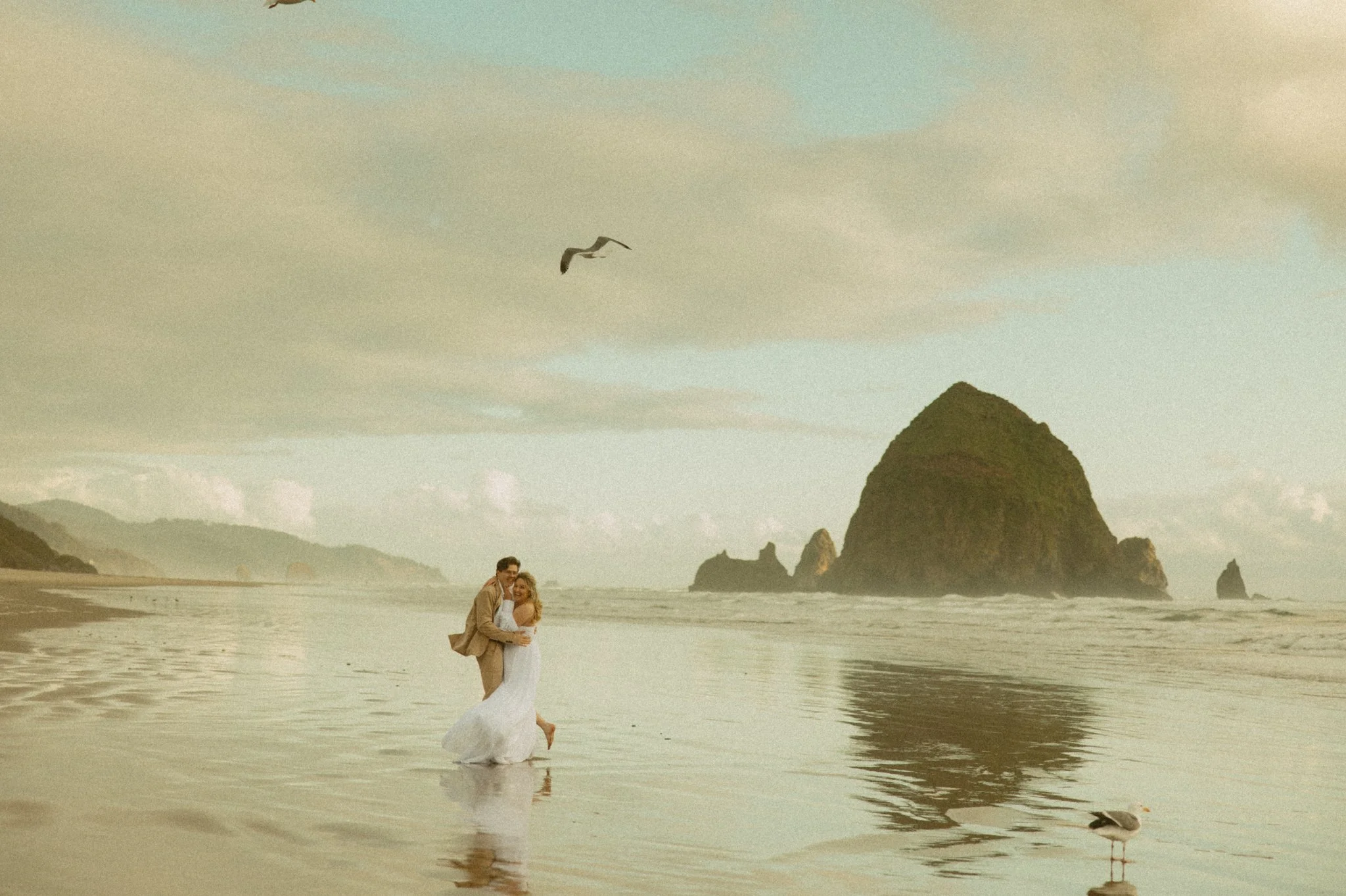 couple eloping on the shore of Cannon Beach in Oregon