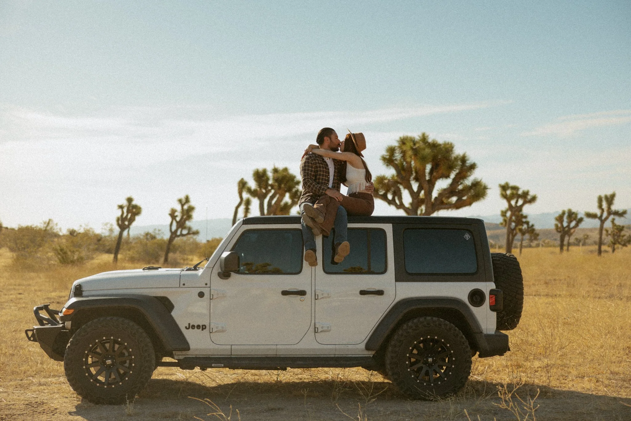 couple jeeping through Joshua Tree, CA as part of their elopement day after session