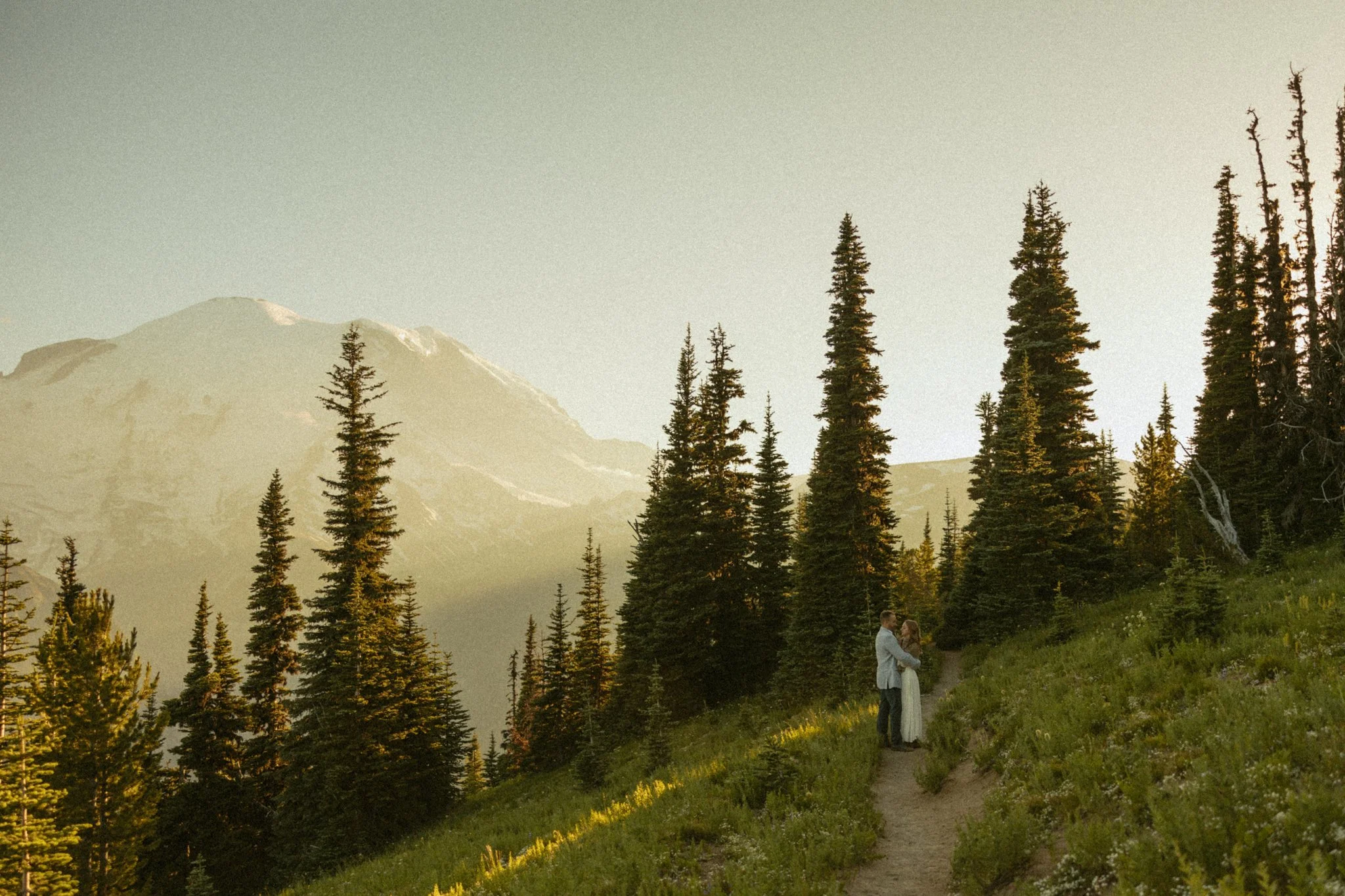 elopement couple hugging on mountain trail in Washington's Mt Rainier National Park
