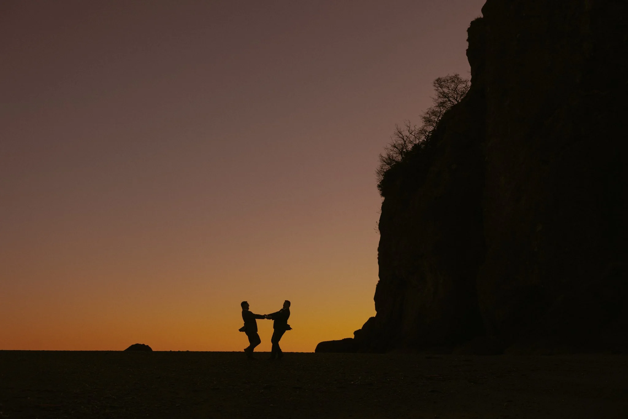 elopement couple running on beach in Olympic National Park at sunset