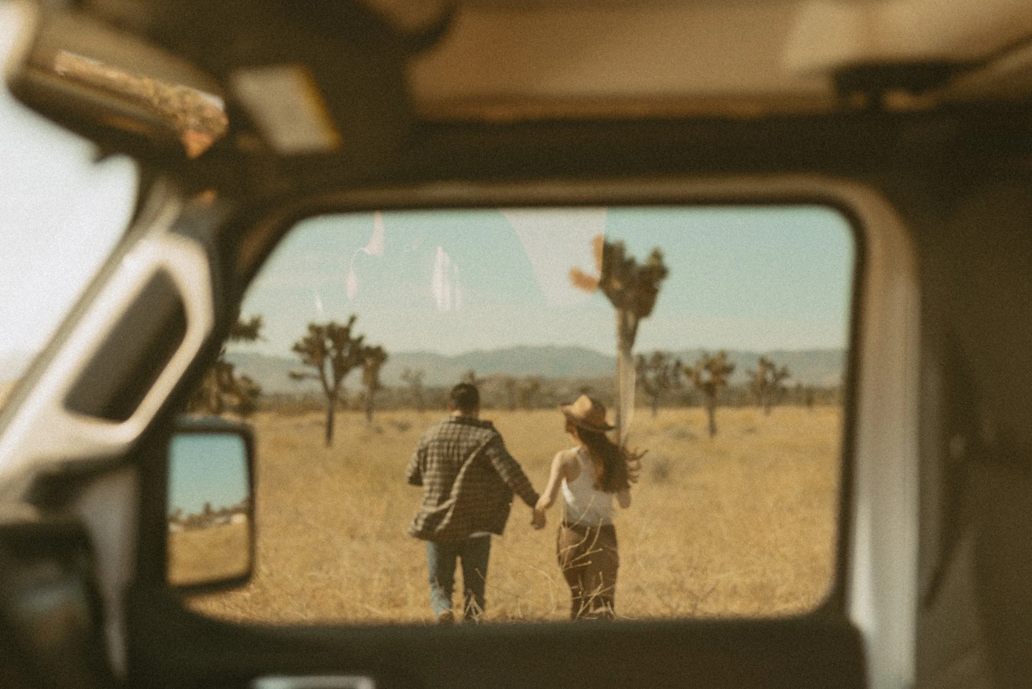 couple jeeping through Joshua Tree on their elopement day in California