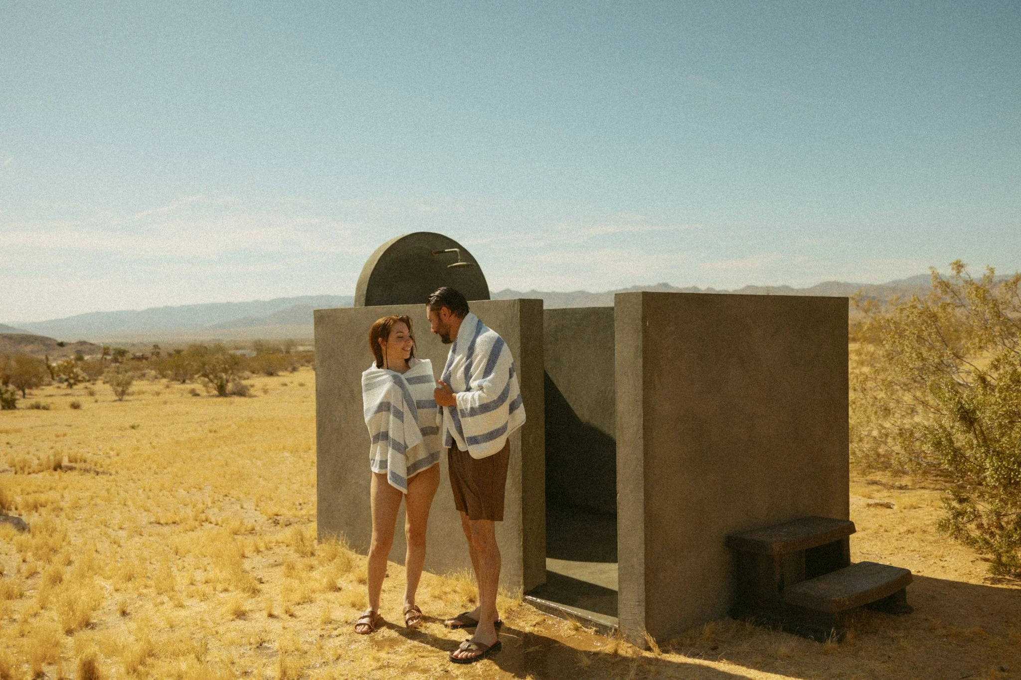 couple getting out of outdoor shower during their Joshua Tree Elopement
