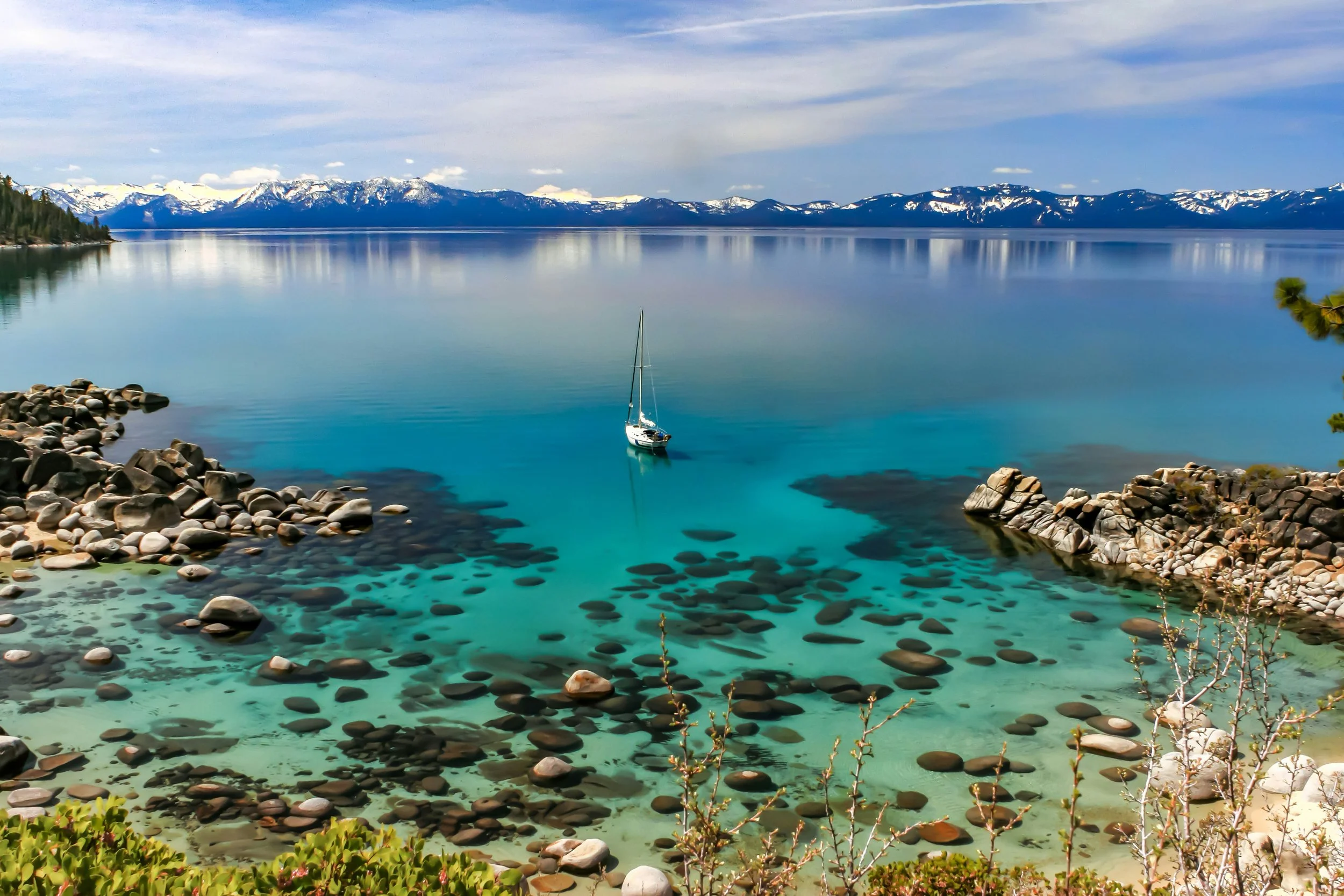 boat in Lake Tahoe with mountains in back