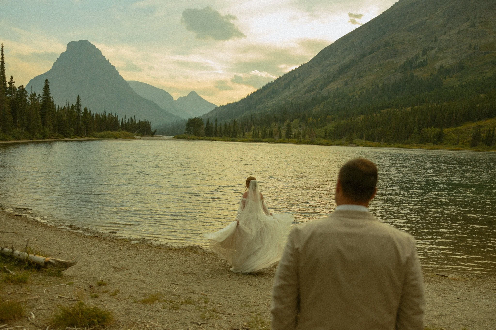 couple eloping on lakeshore in Montana's Glacier National Park