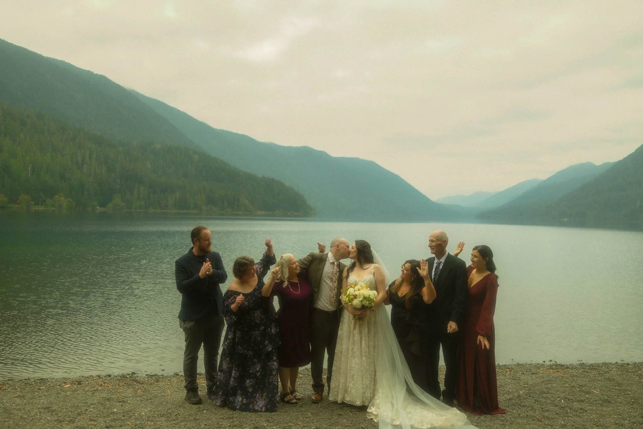an elopement couple celebrating with their family along the shore of Lake Crescent