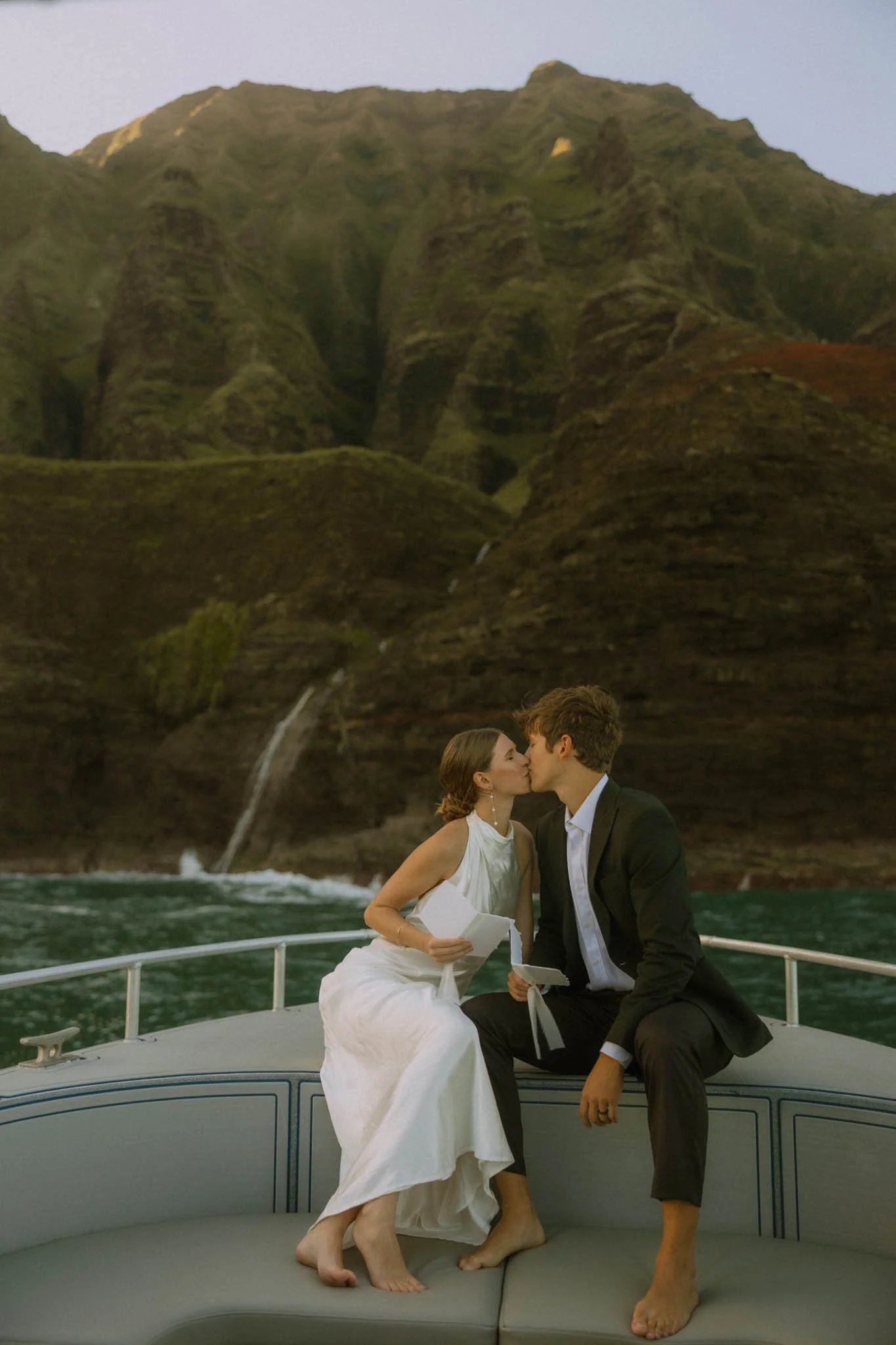 elopement couple sharing vows on a private boat charter along the Na Pali Coast in Kauai