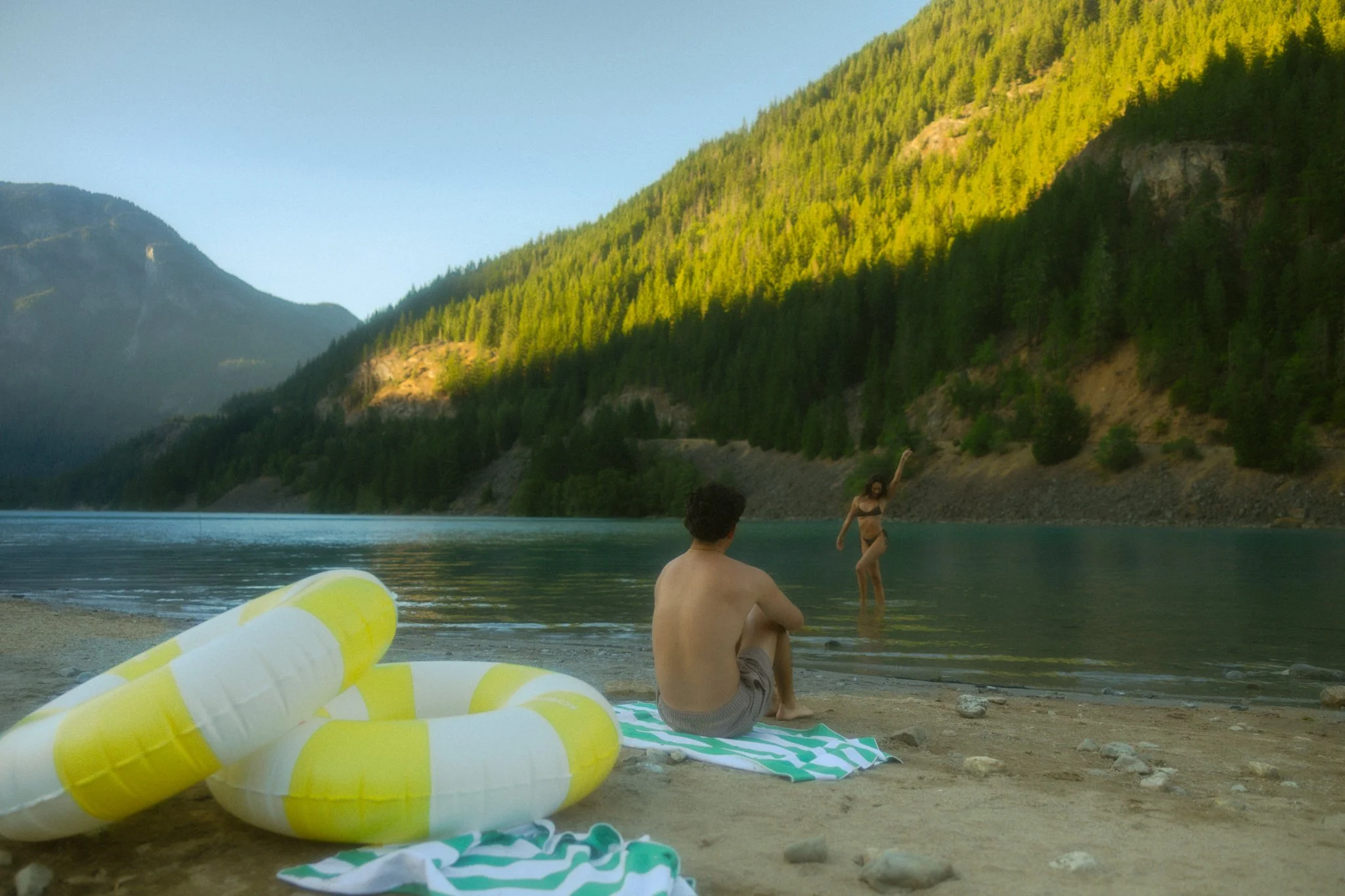 an elopement couple swimming in an alpine lake in the North Cascades
