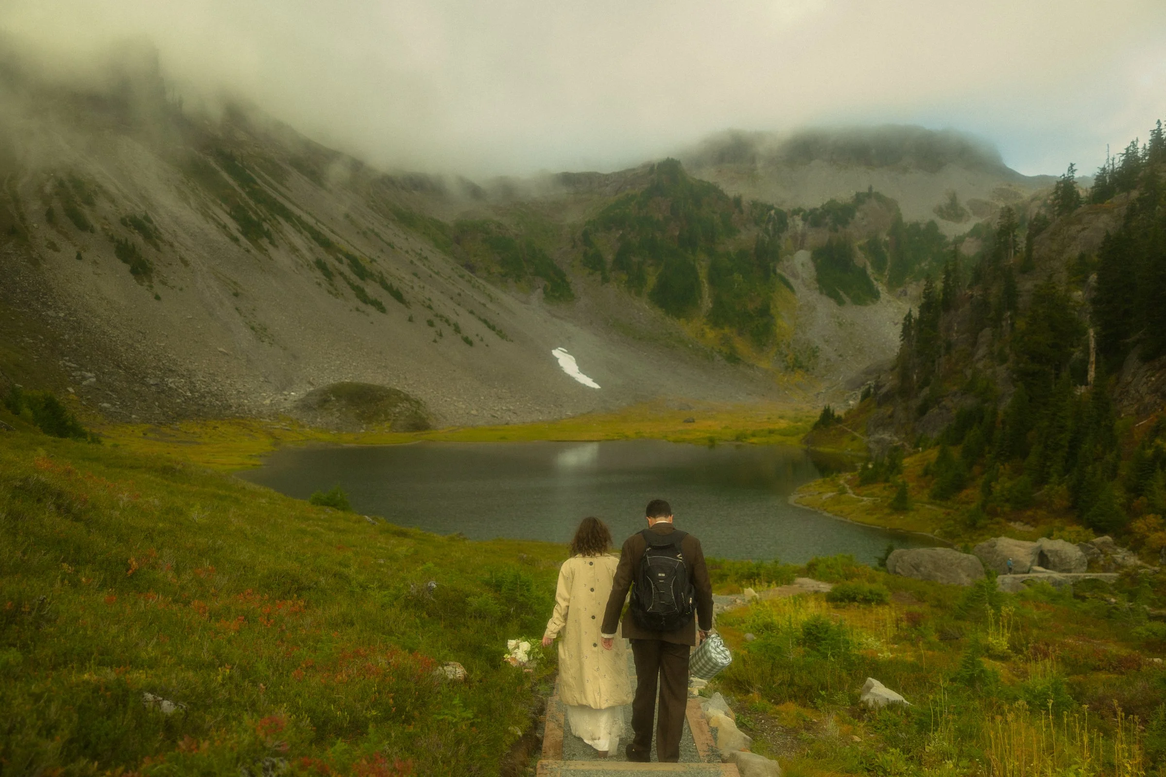 an elopement couple hiking down to Heather Meadows