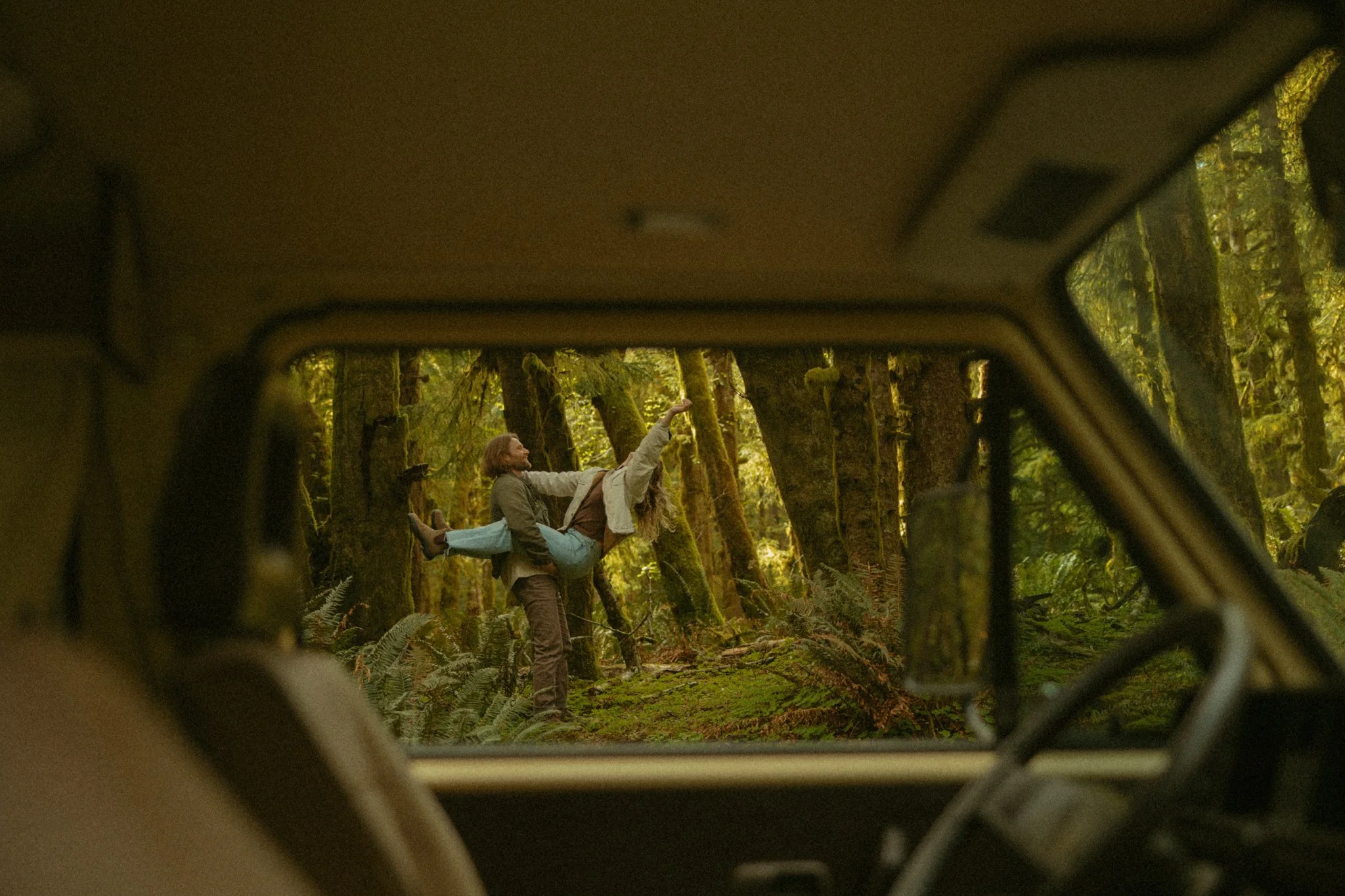 couple frolicking in Oregon forest