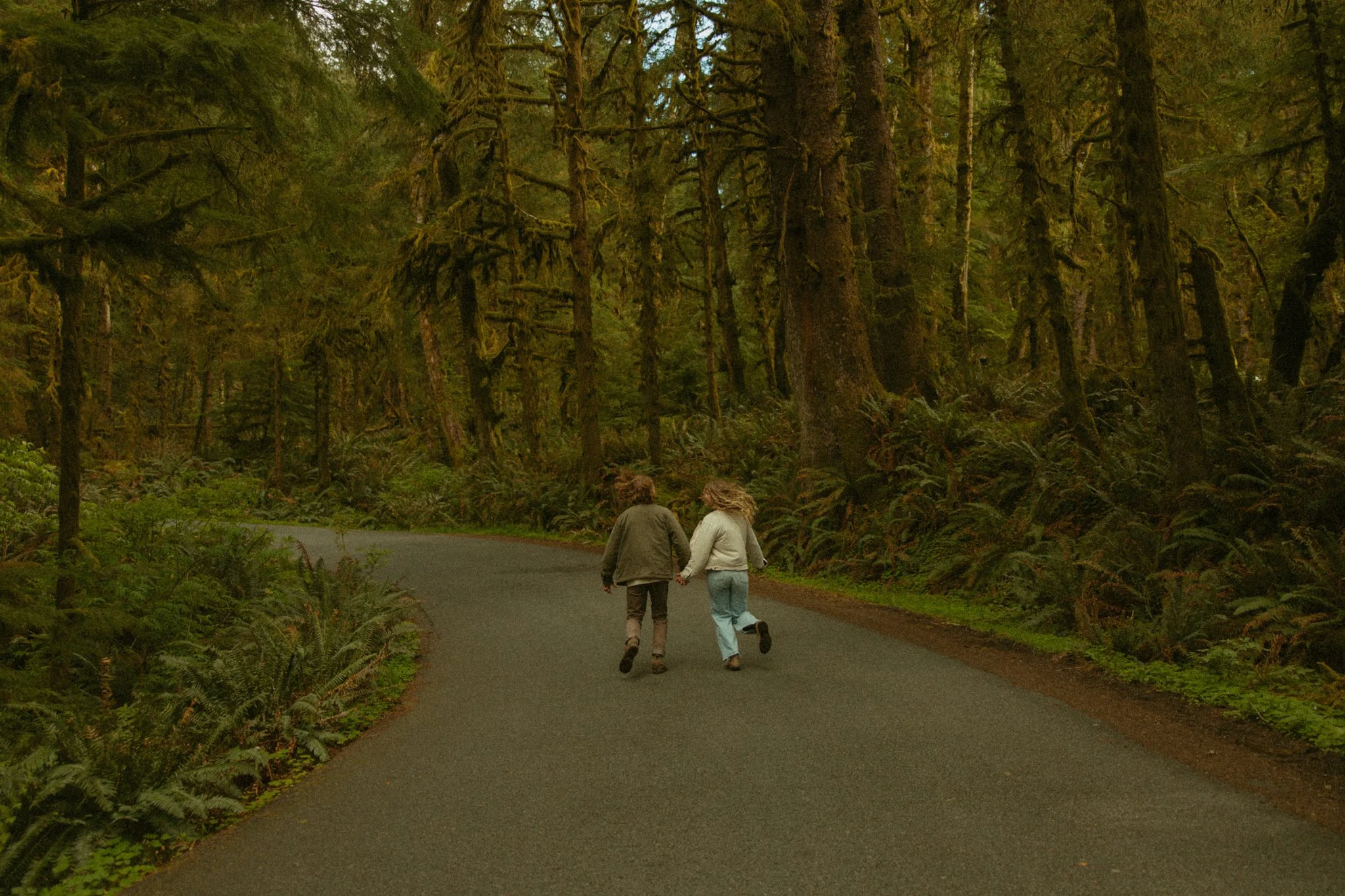 couple running in forest roads