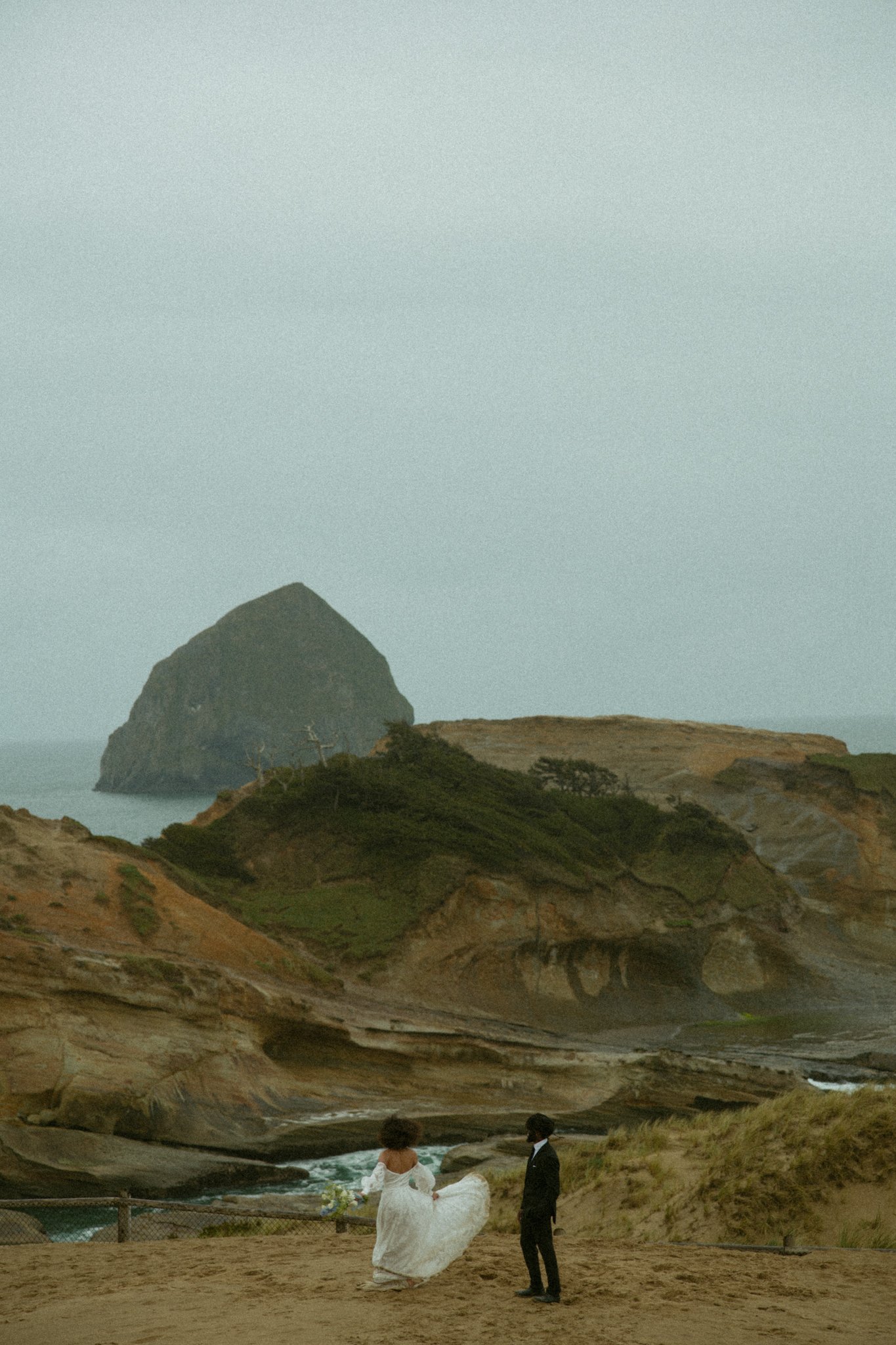 elopement couple dancing on cliffs at Cape Kiwanda in Oregon