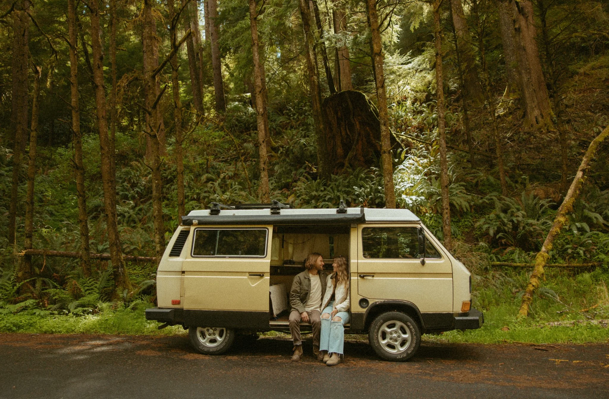 a couple getting ready in their converted van before their elopement day in the Oregon forest