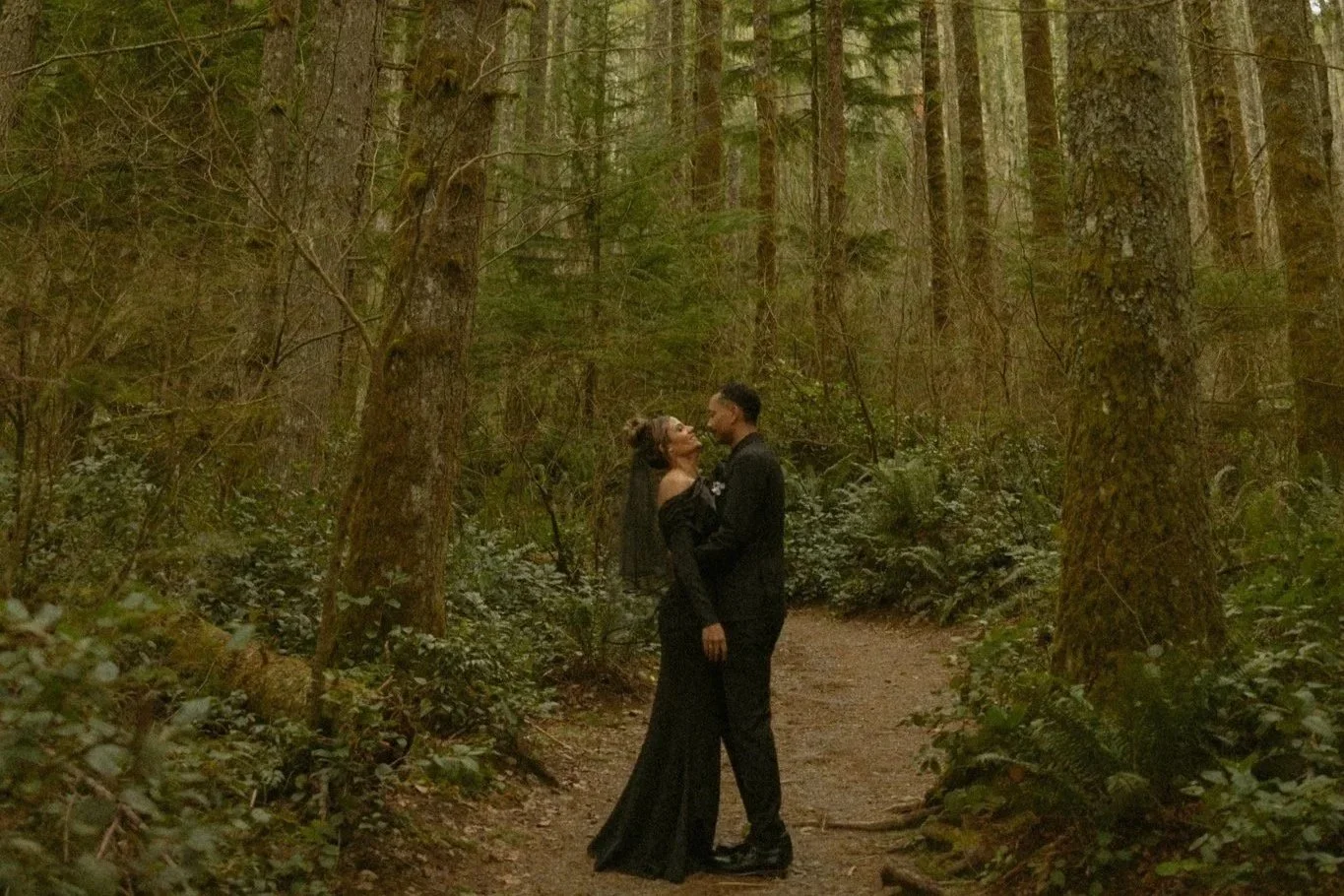 a winter elopement couple embracing in the forest