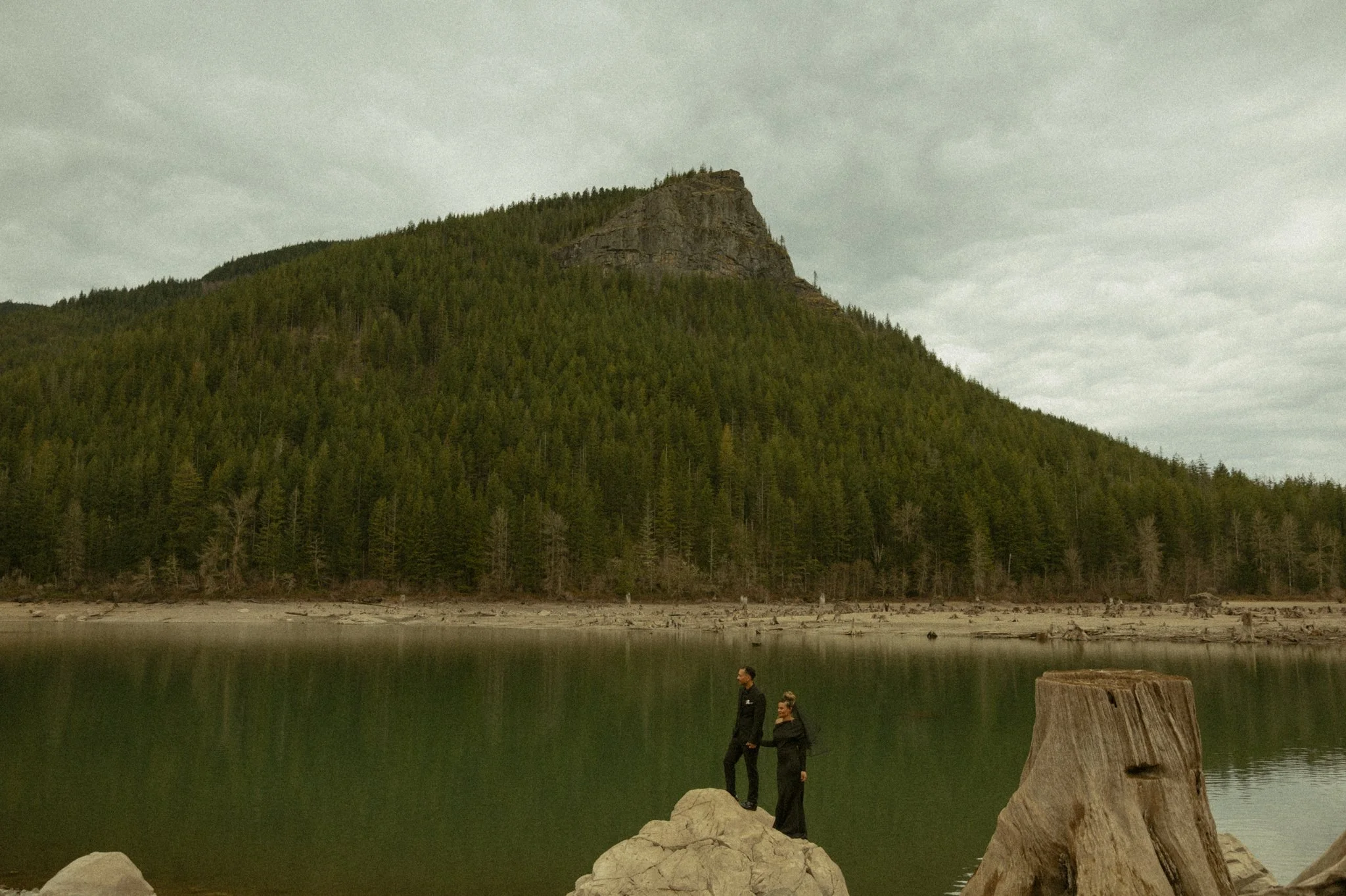 an elopement couple standing at the base of a lake on their winter elopement day