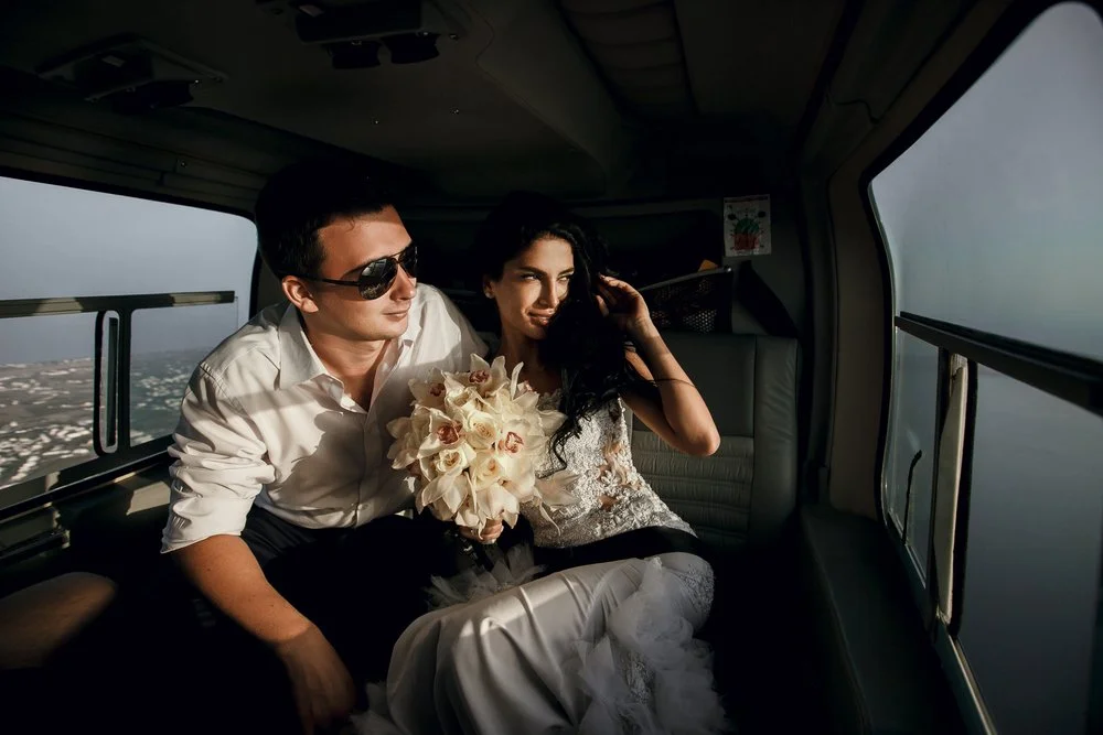 elopement couple riding a helicopter
