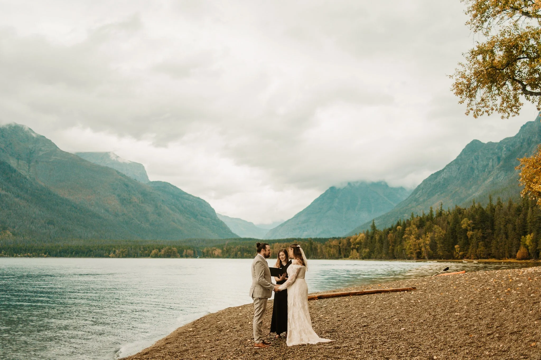 couple getting married on the shore of Lake McDonald in Glacier National Park