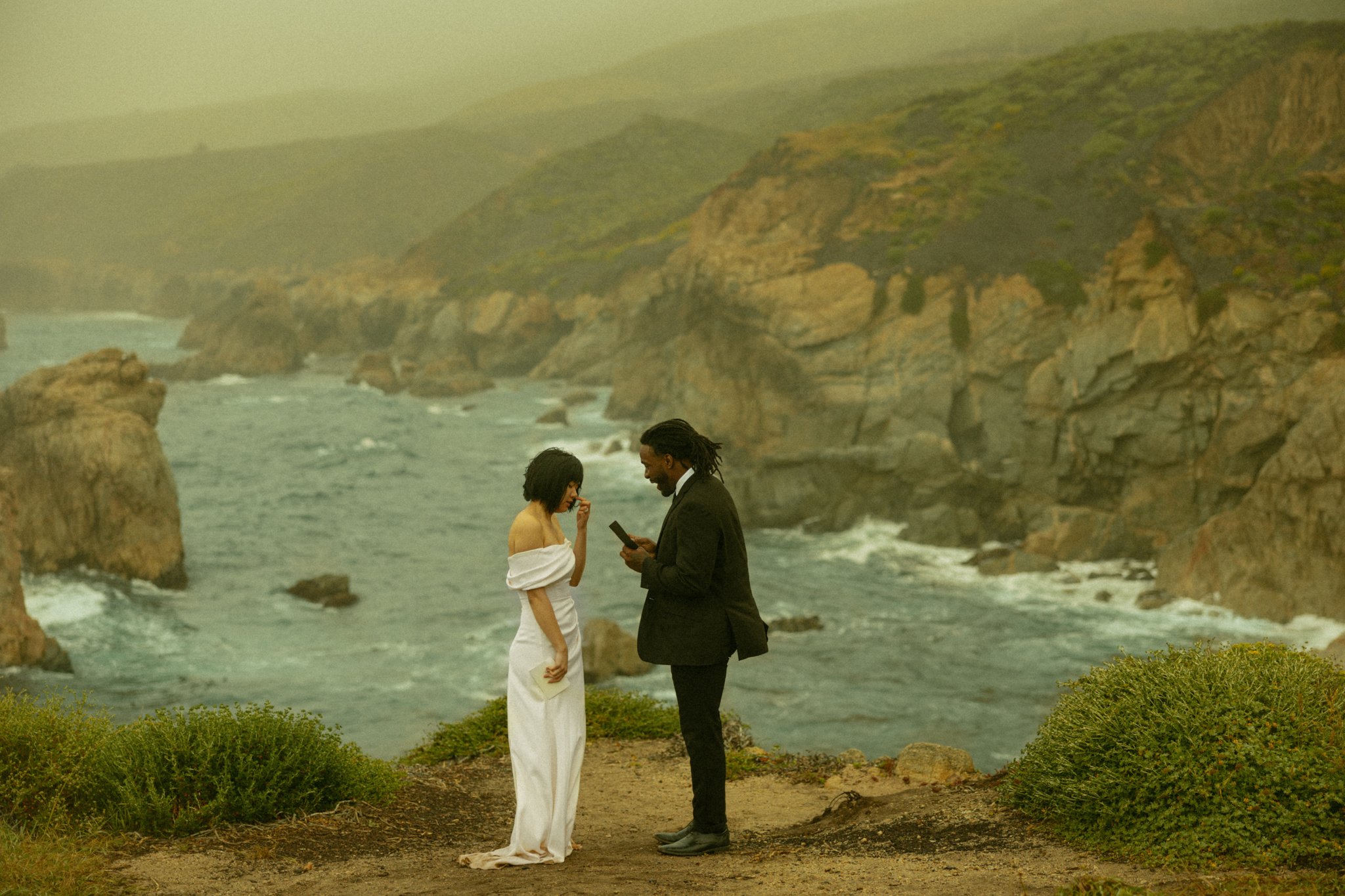 couple saying their vows on an ocean cliffside in California's Big Sur