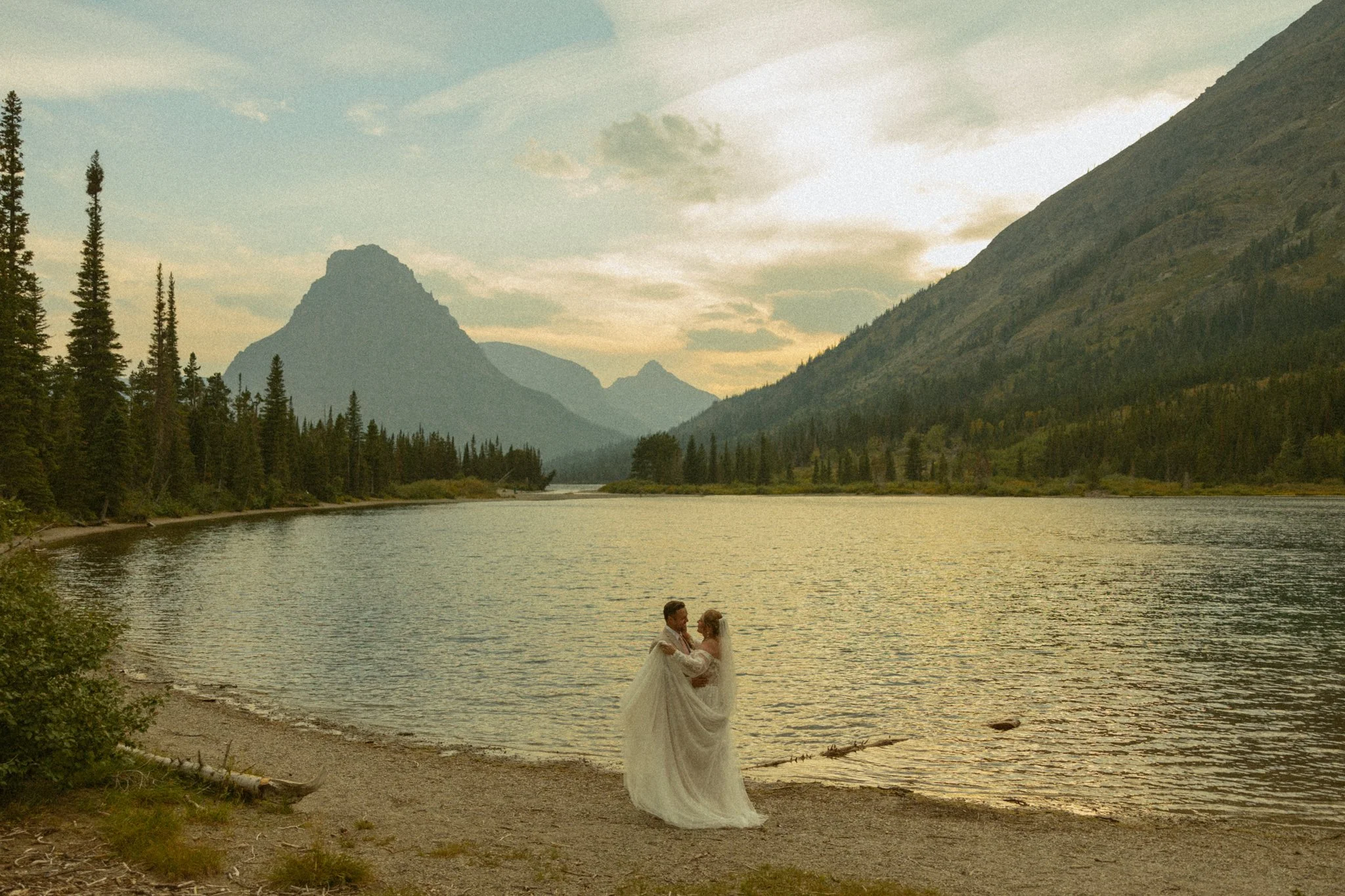 elopement couple on lakeshore in Montana's Glacier National Park