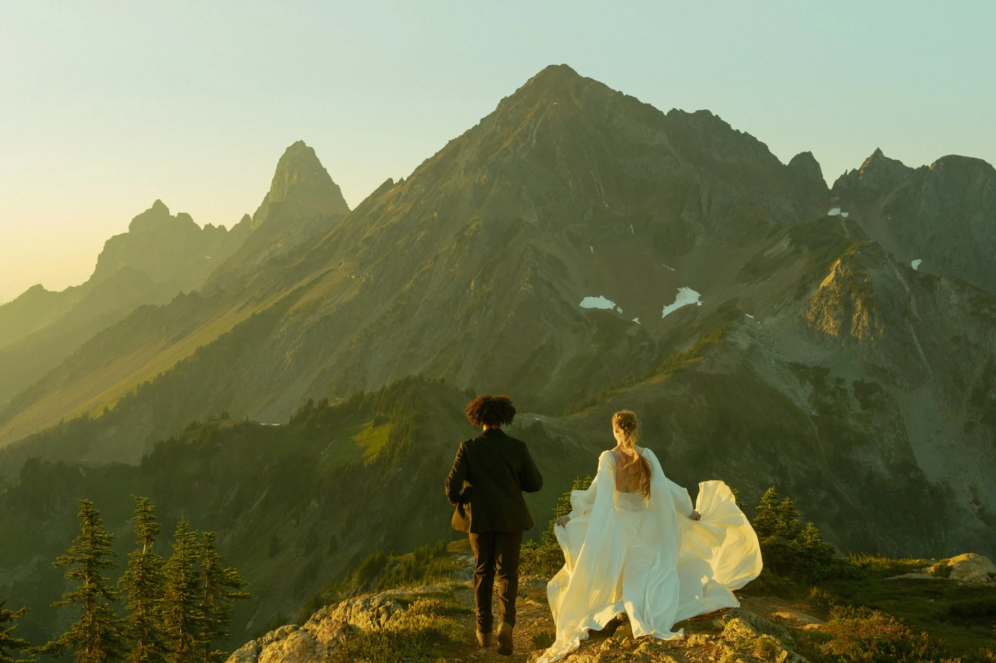 elopement couple running in mountains in Washington's North Cascades