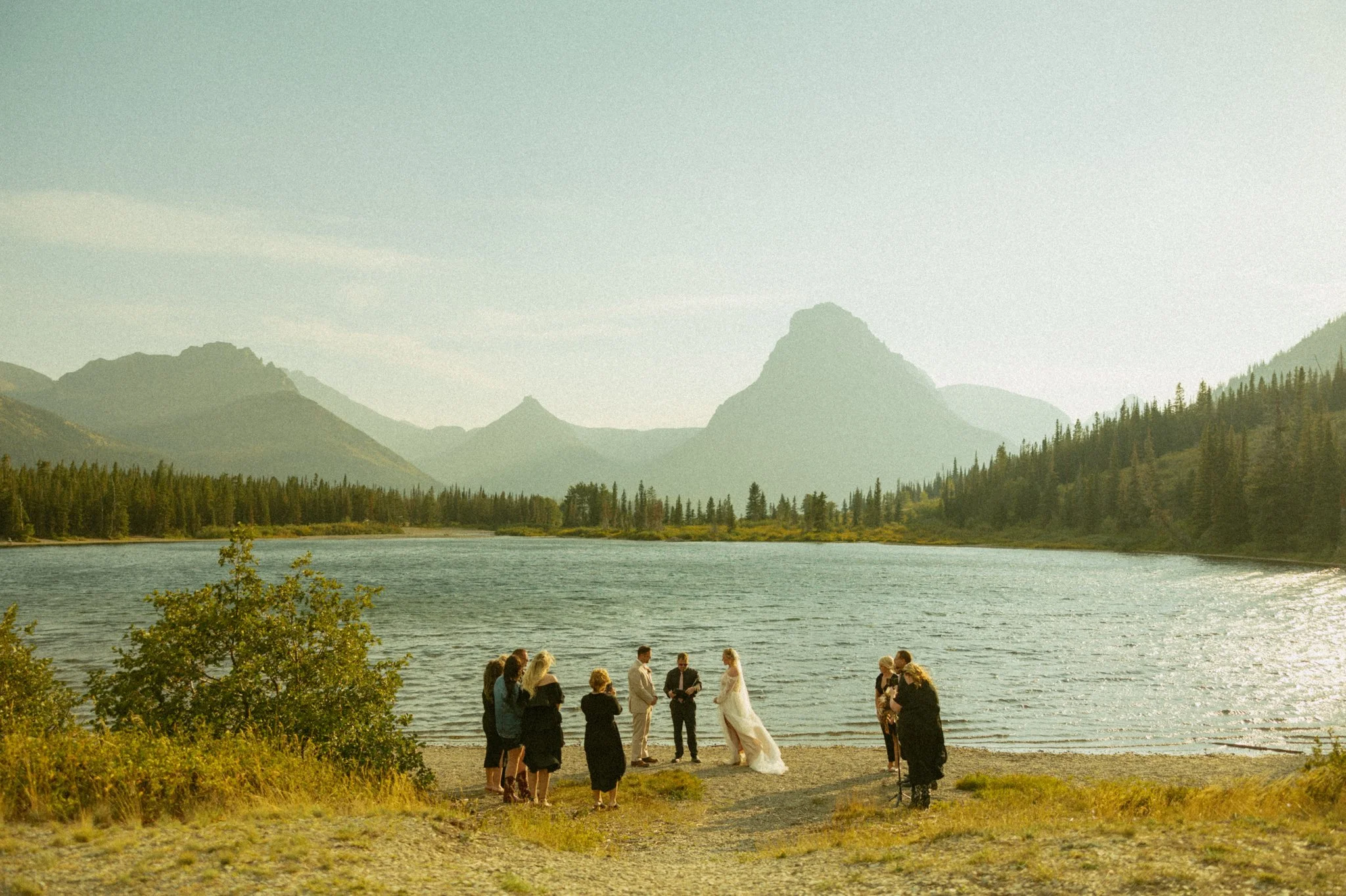 couple getting married next to an alpine lake in Montana's Glacier National Park