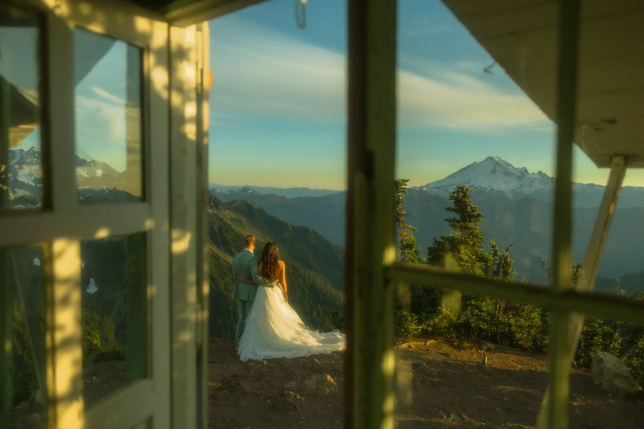 a couple eloping on top of a mountain with a fire lookout in the North Cascades
