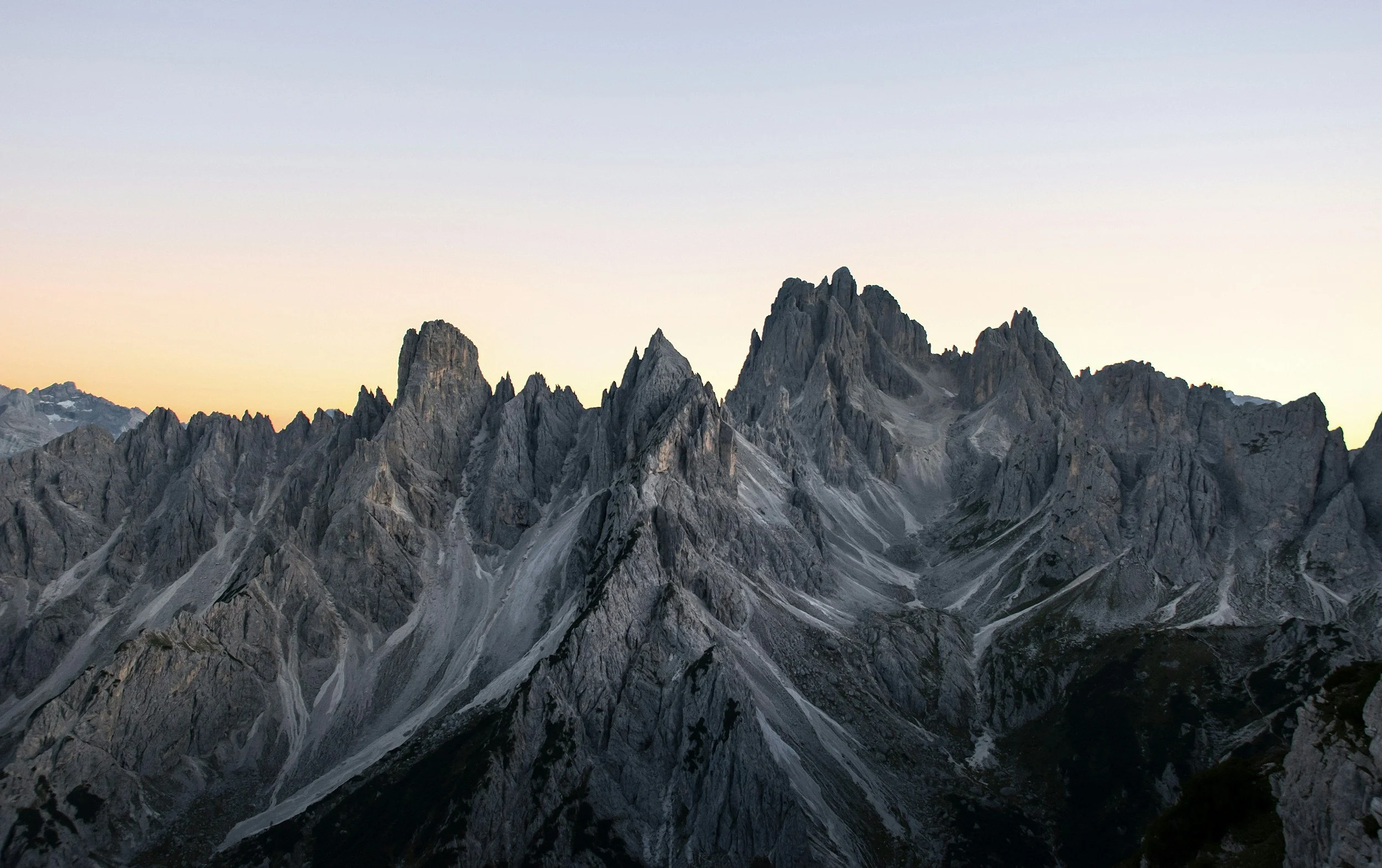 a landscape photo of the rugged and jagged mountain peaks of the Dolomites