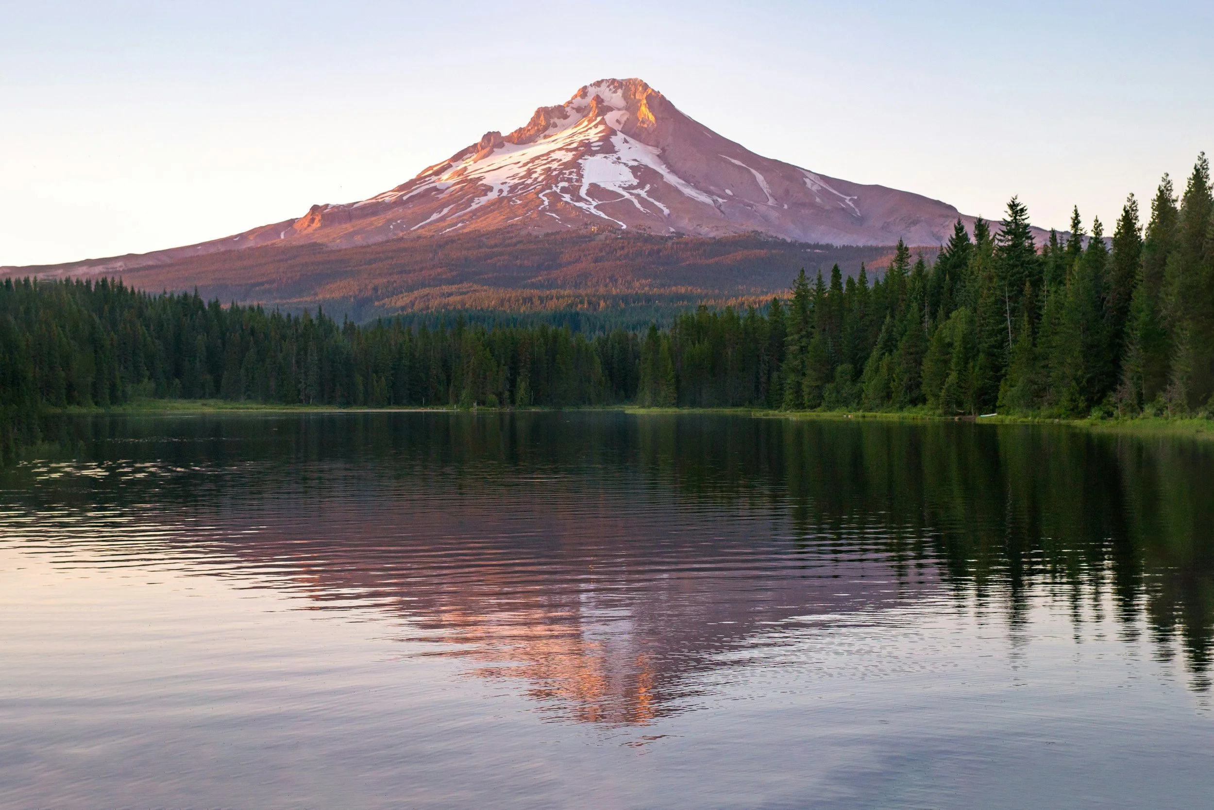 a landscape photo of a lake with Mt Hood in the distance