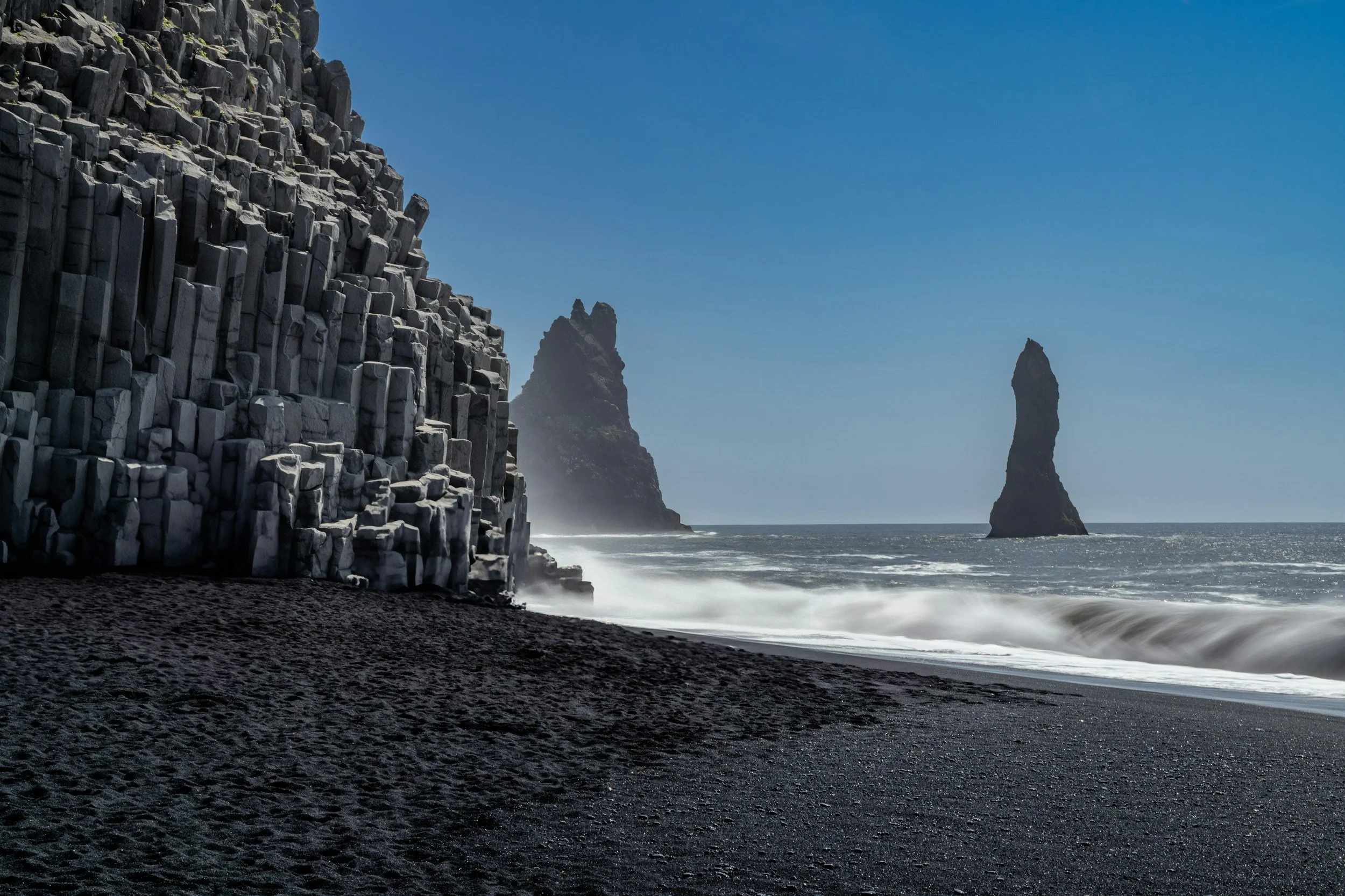 a landscape photo of the black sand Reynisfjara Beach in Iceland