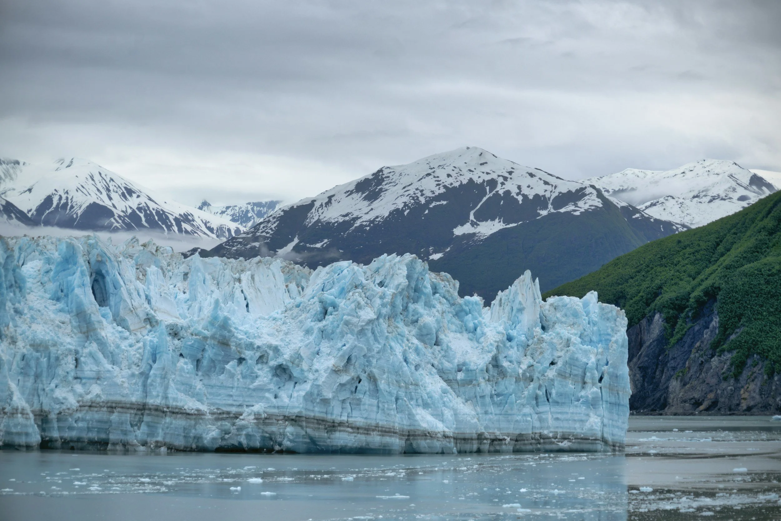 a landscape photo of a glacier and mountains in Alaska