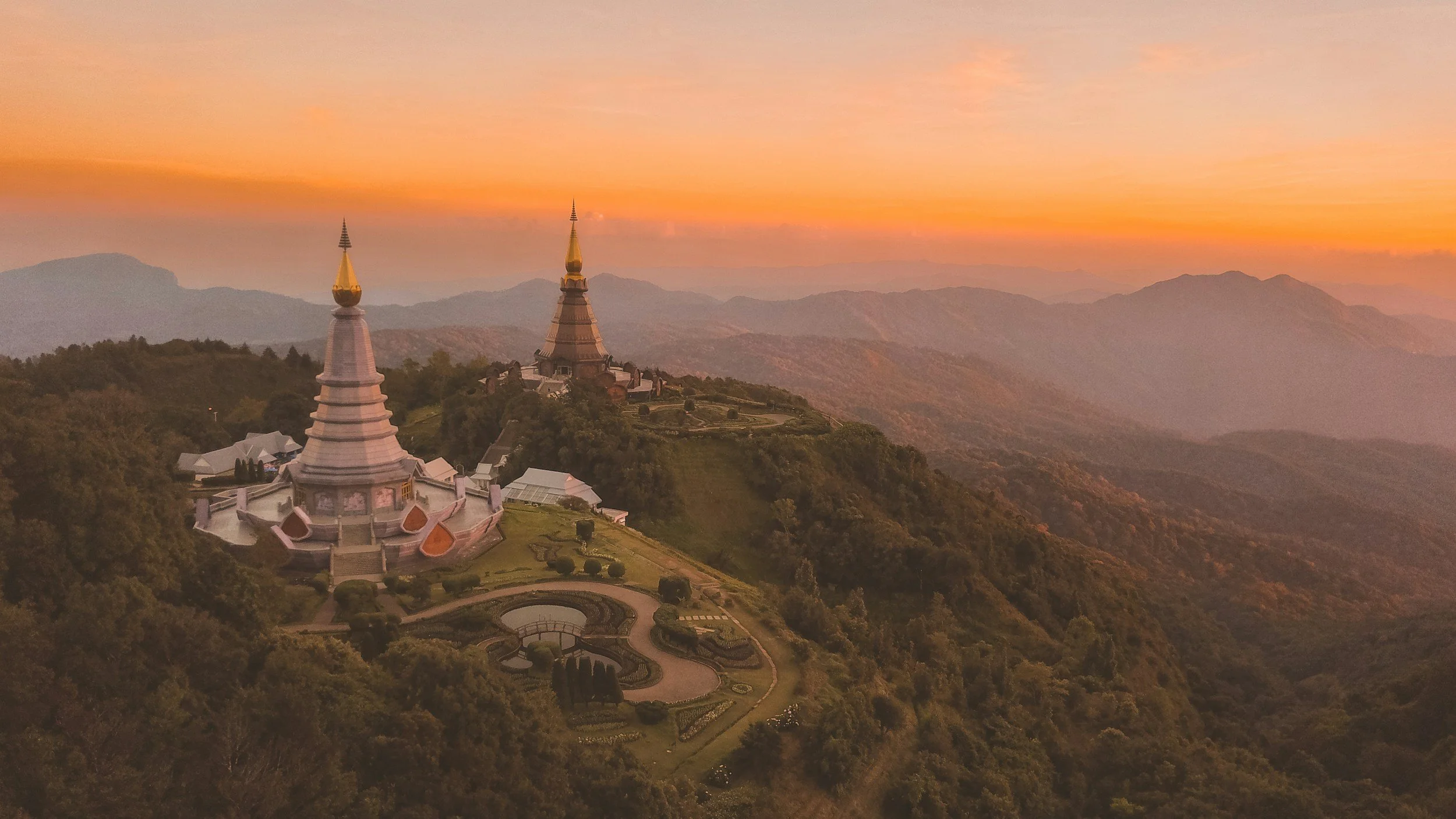 an aerial photo of some temples on a mountain in Thailand