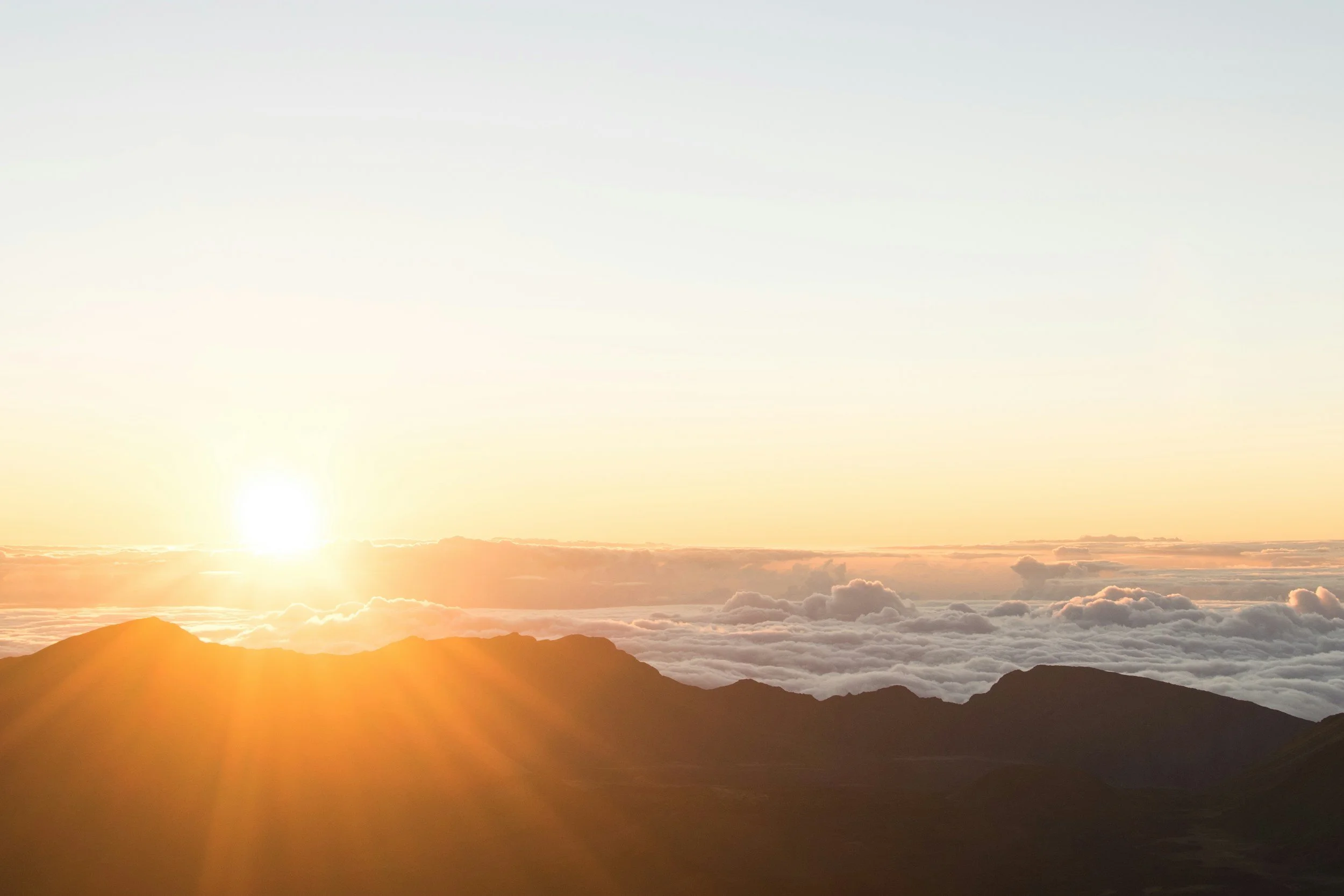 the sunrise above the clouds at Haleakala National Park on Maui