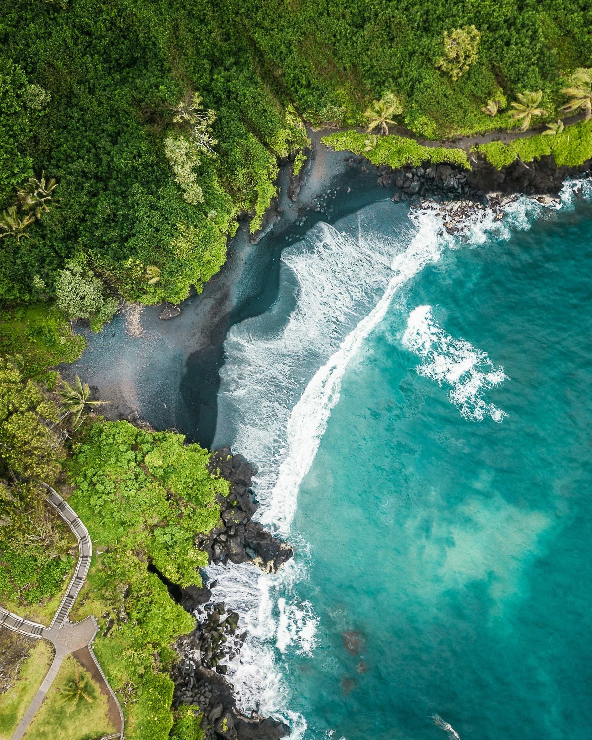 aerial view of a black sand beach along the Road to Hana in Maui, Hawaii