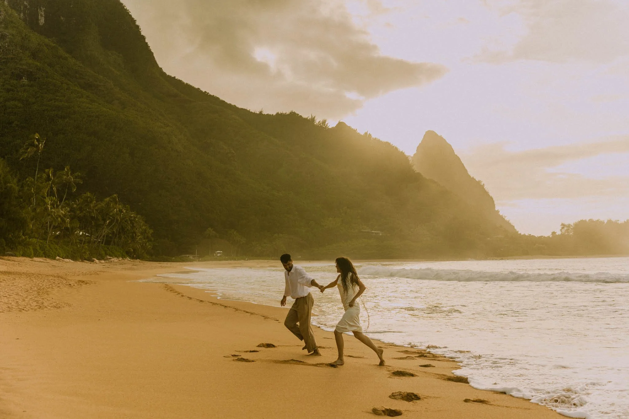 a couple eloping on a beach in Hawaii at sunset