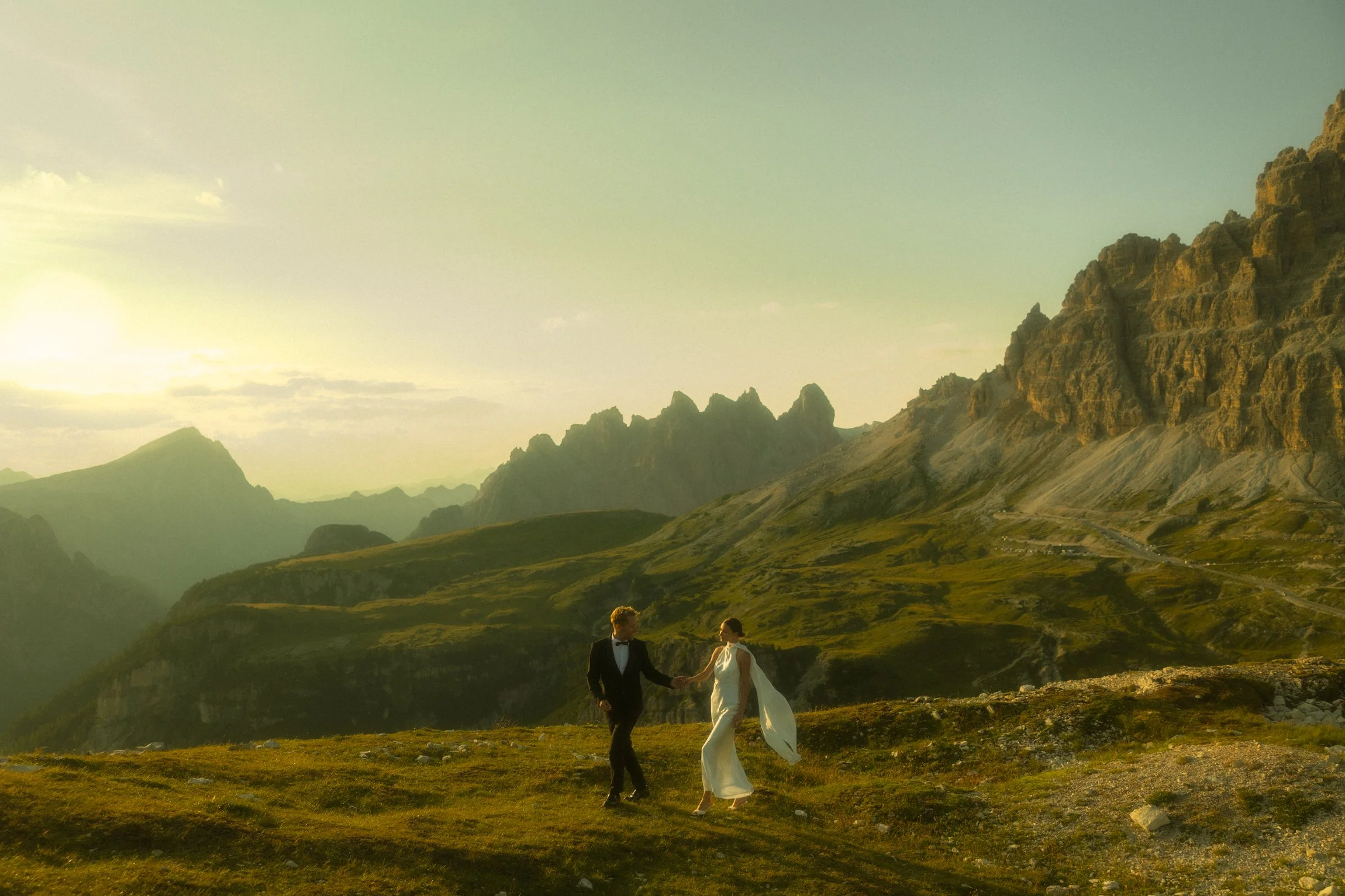 an elopement couple walking along a mountain ridge in the Dolomites