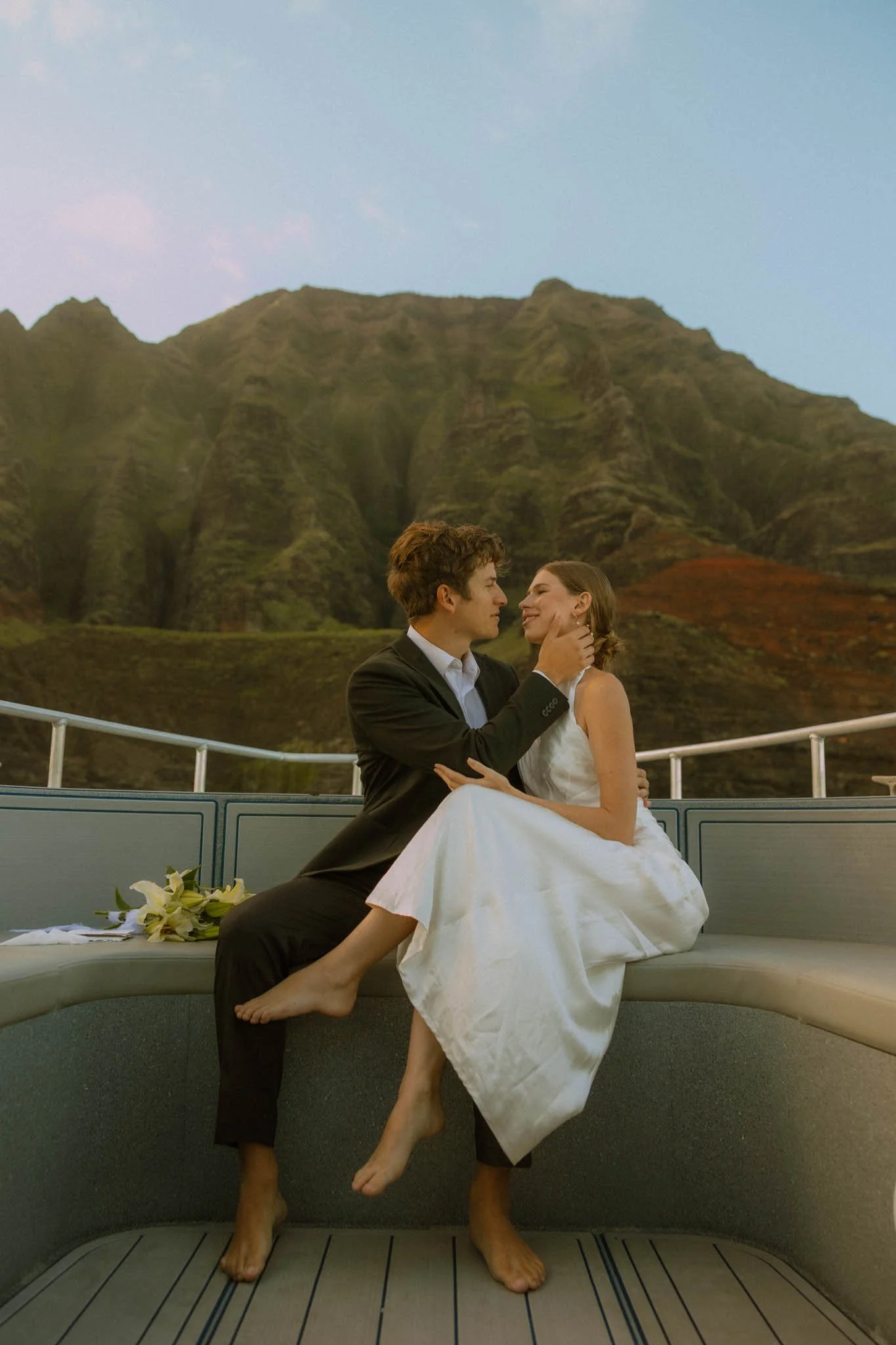 a wedding couple on a private Na Pali Coast boat tour on the island of Kauai