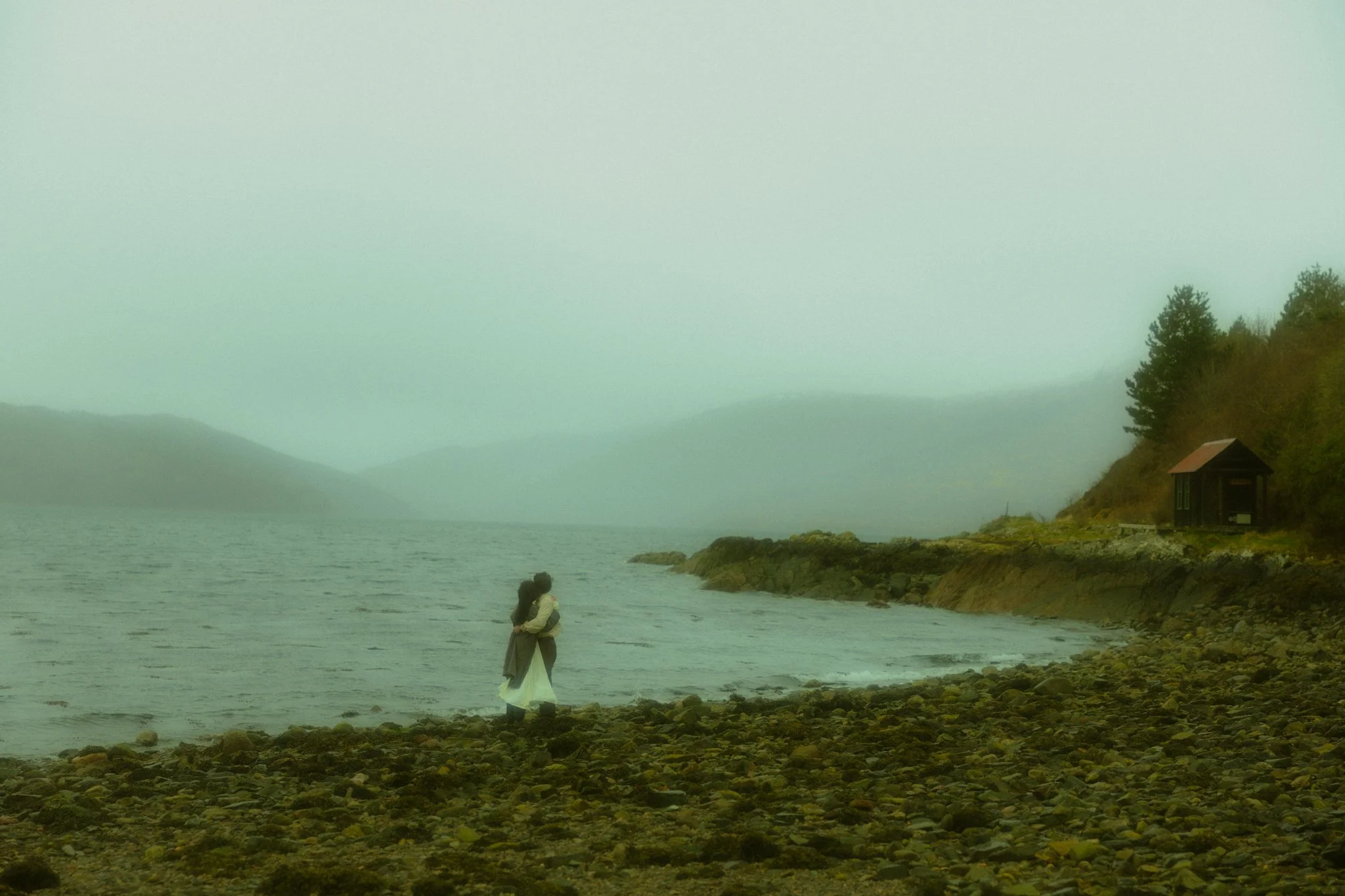 a couple getting married along a lake in the Scottish Highlands on a rainy day