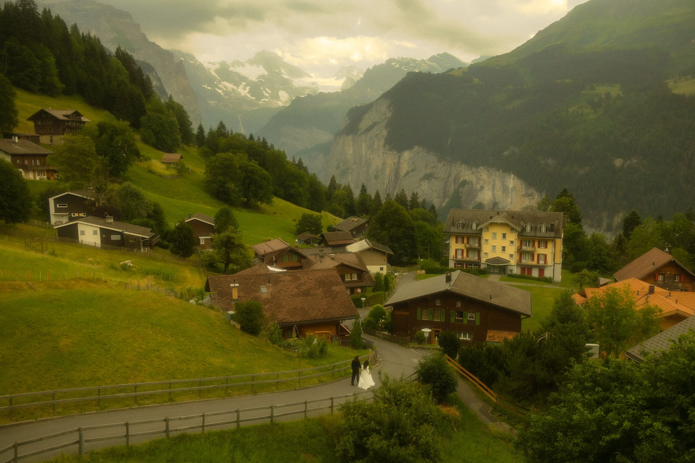 an elopement couple walking along the road in a small alpine village in Switzerland