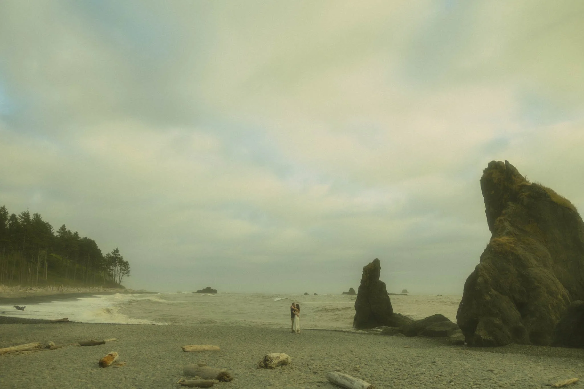a couple hugging on Ruby Beach in Olympic National Park