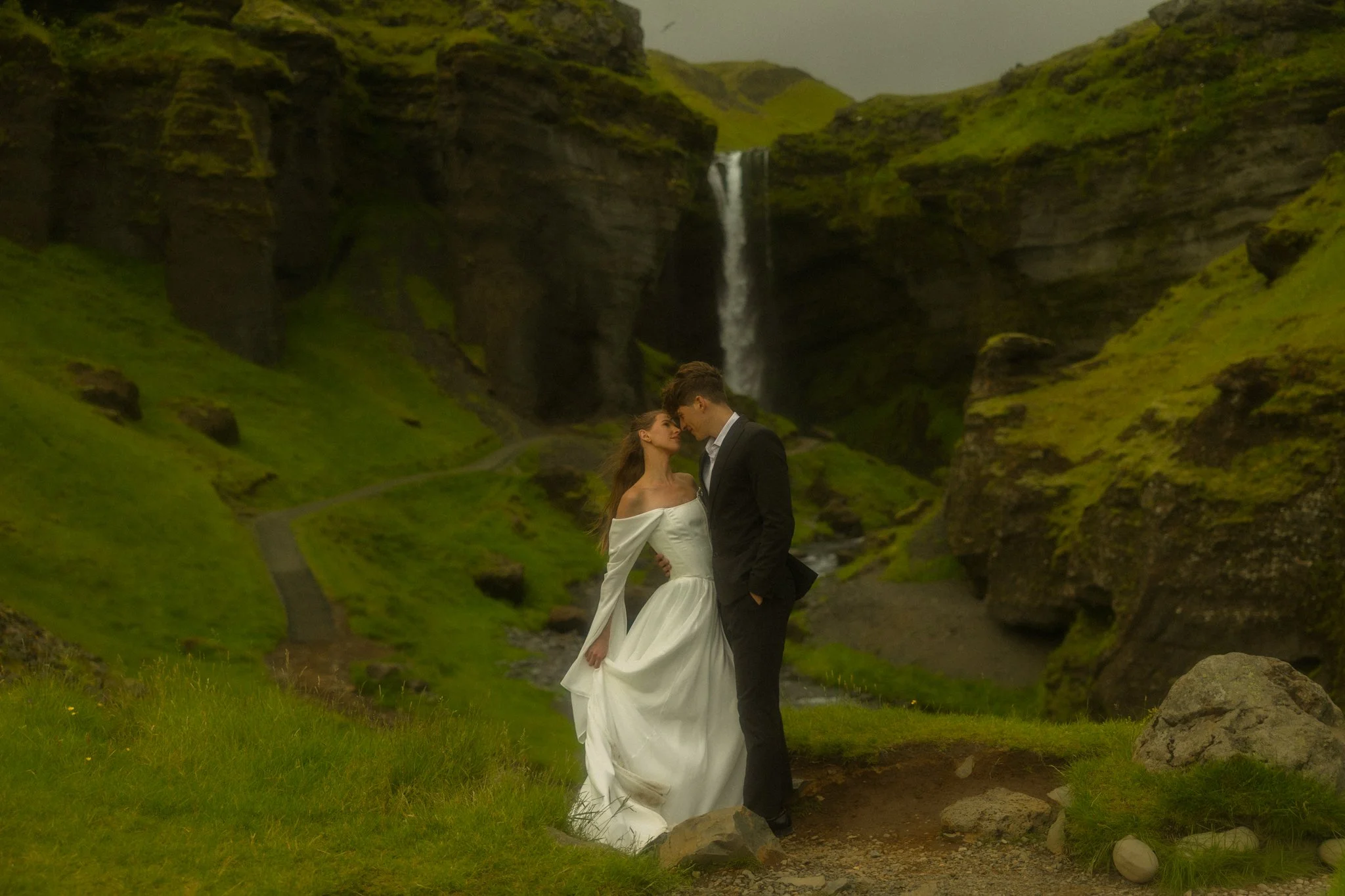an elopement couple embracing in a waterfall canyon along the South Coast of Iceland