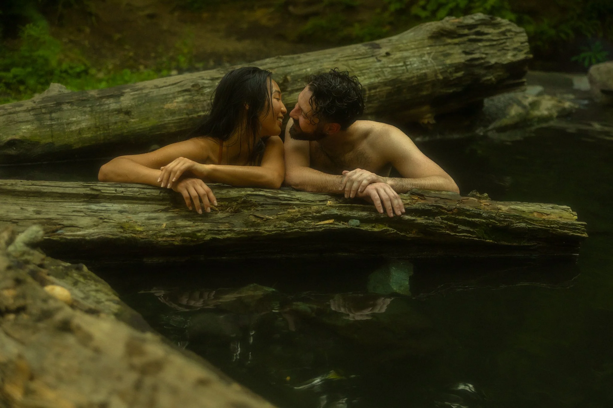 a couple relaxing in a hot spring after their elopement day