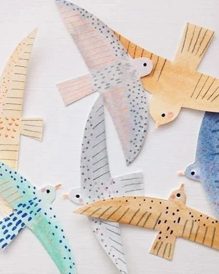 Collection of handmade paper birds with colorful patterns and designs.