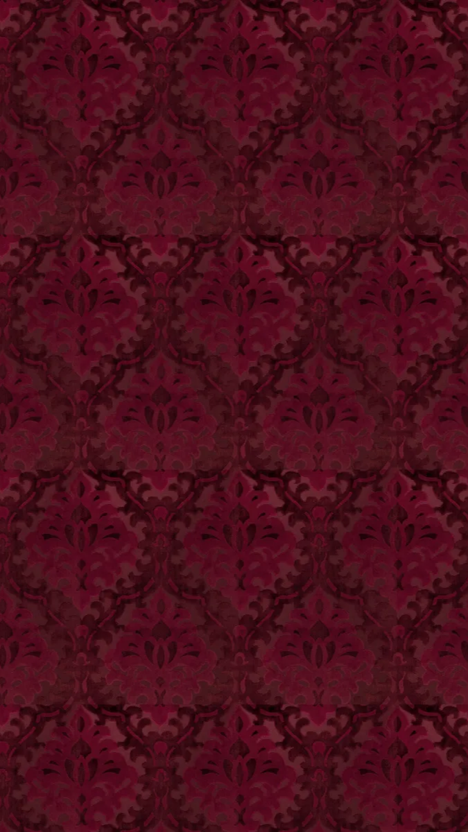 Dark red damask patterned wallpaper with intricate floral motifs.