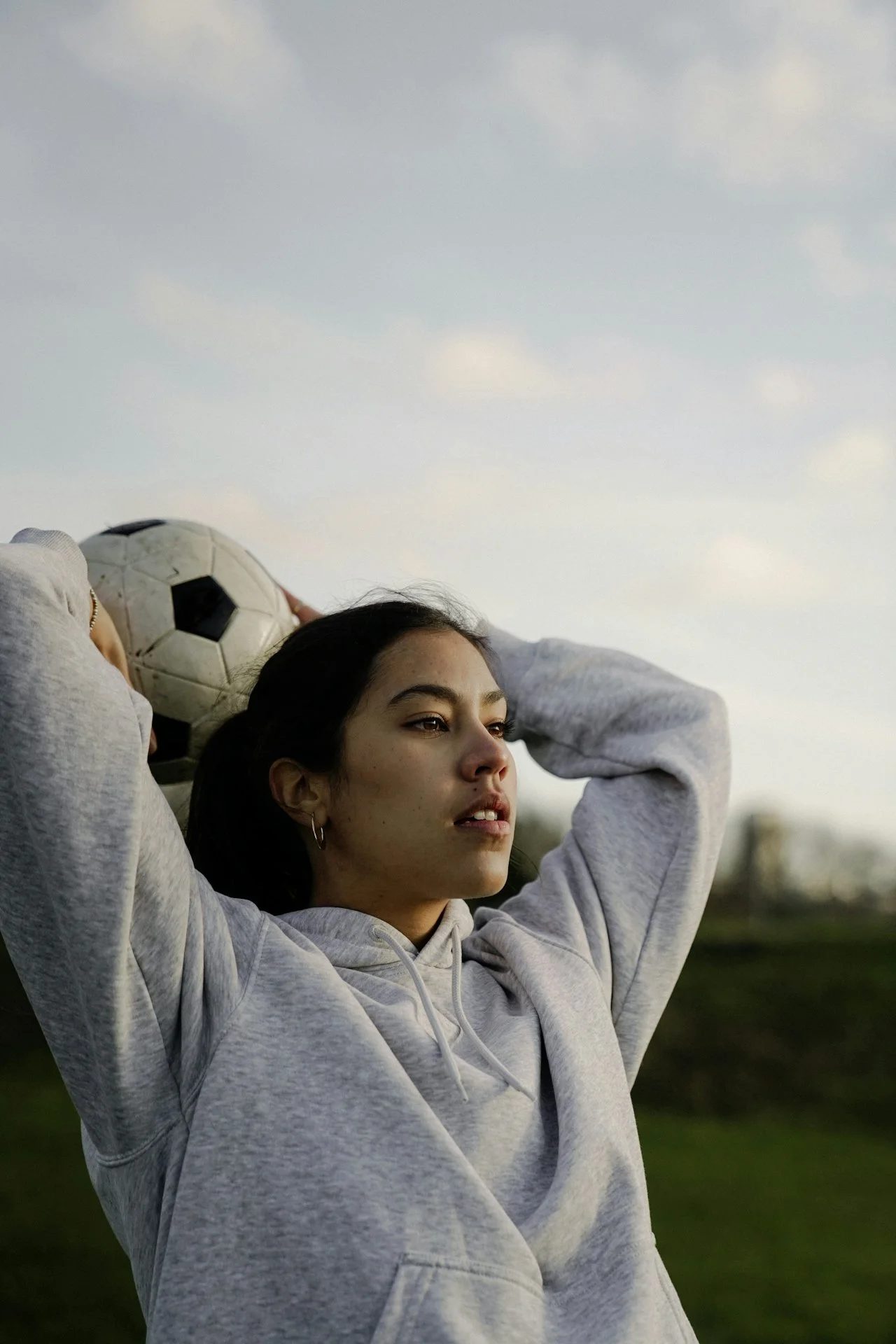 young soccer player holding a ball representing youth athlete confidence and development