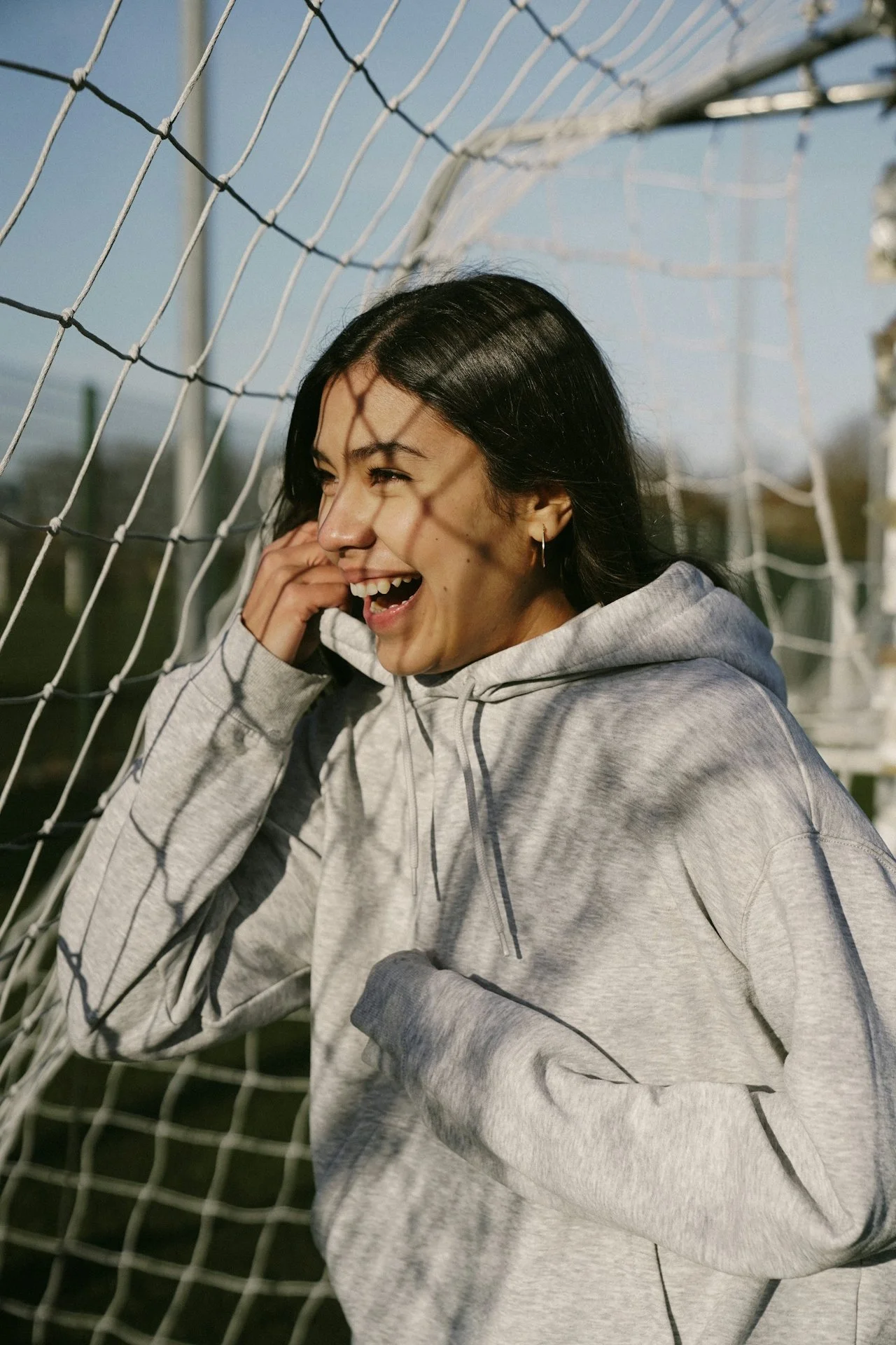 young athlete smiling on a soccer field representing confidence and a positive relationship with sport