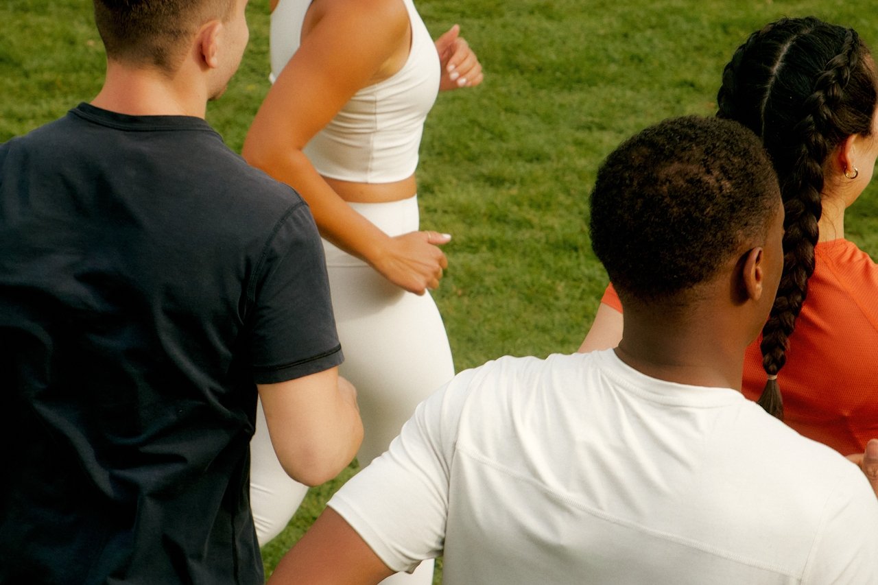 group of athletes running together in a supportive training environment focused on performance and wellbeing