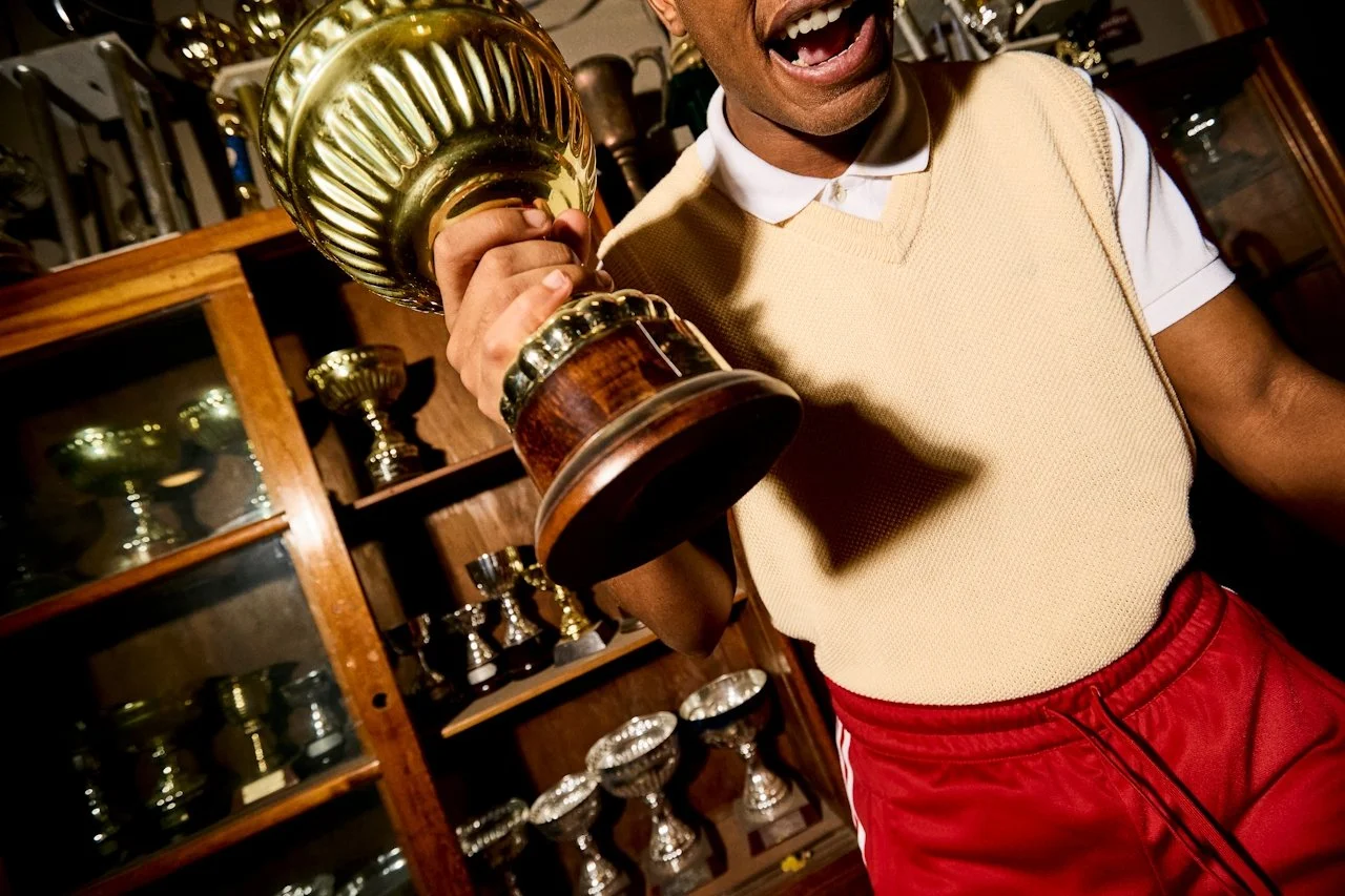 athlete holding a trophy representing confidence and returning to sport after recovery