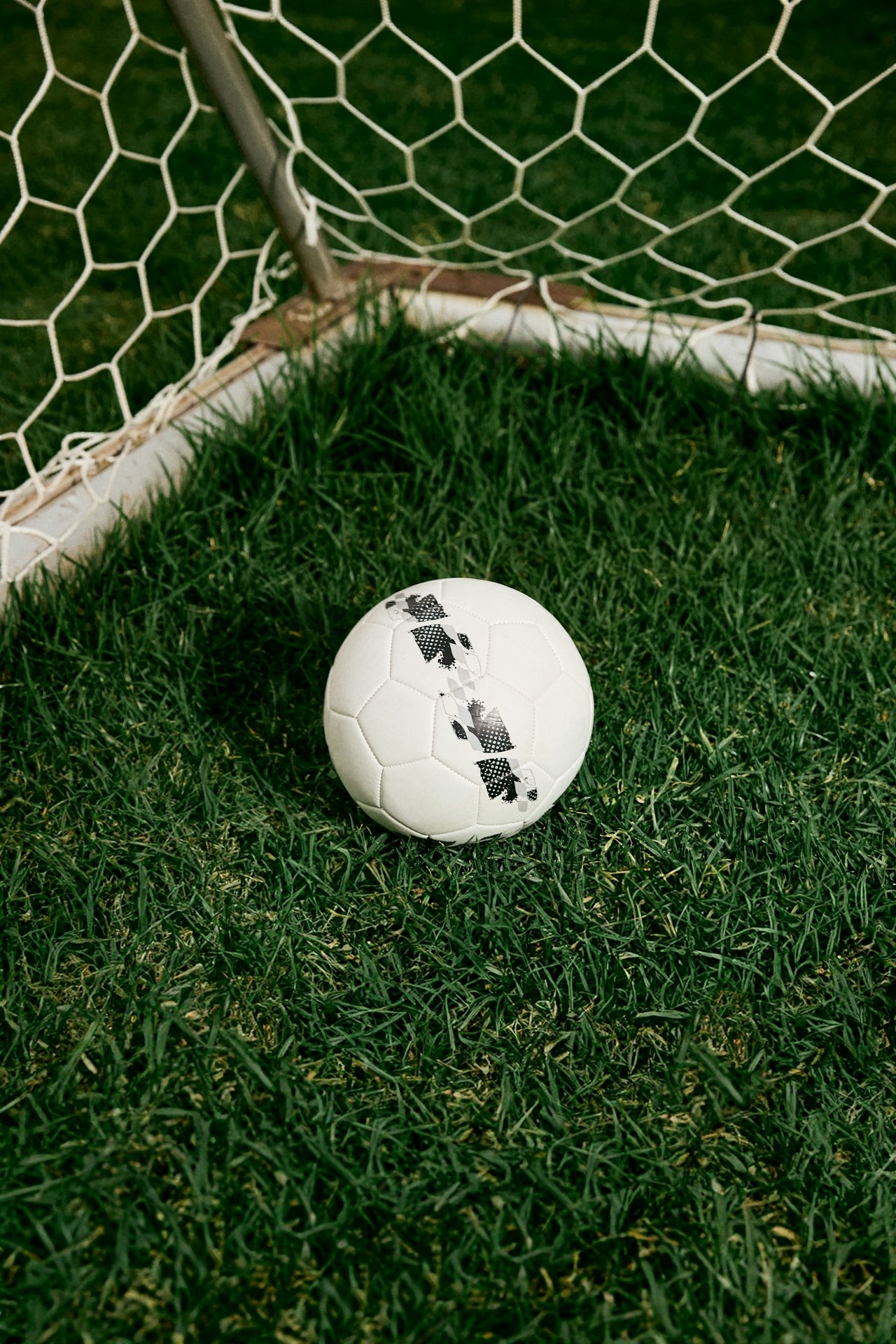 soccer ball on a field representing the work of a sport psychologist supporting athletes behind the scenes